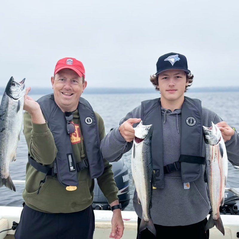 Father and Son with freshly caught salmon