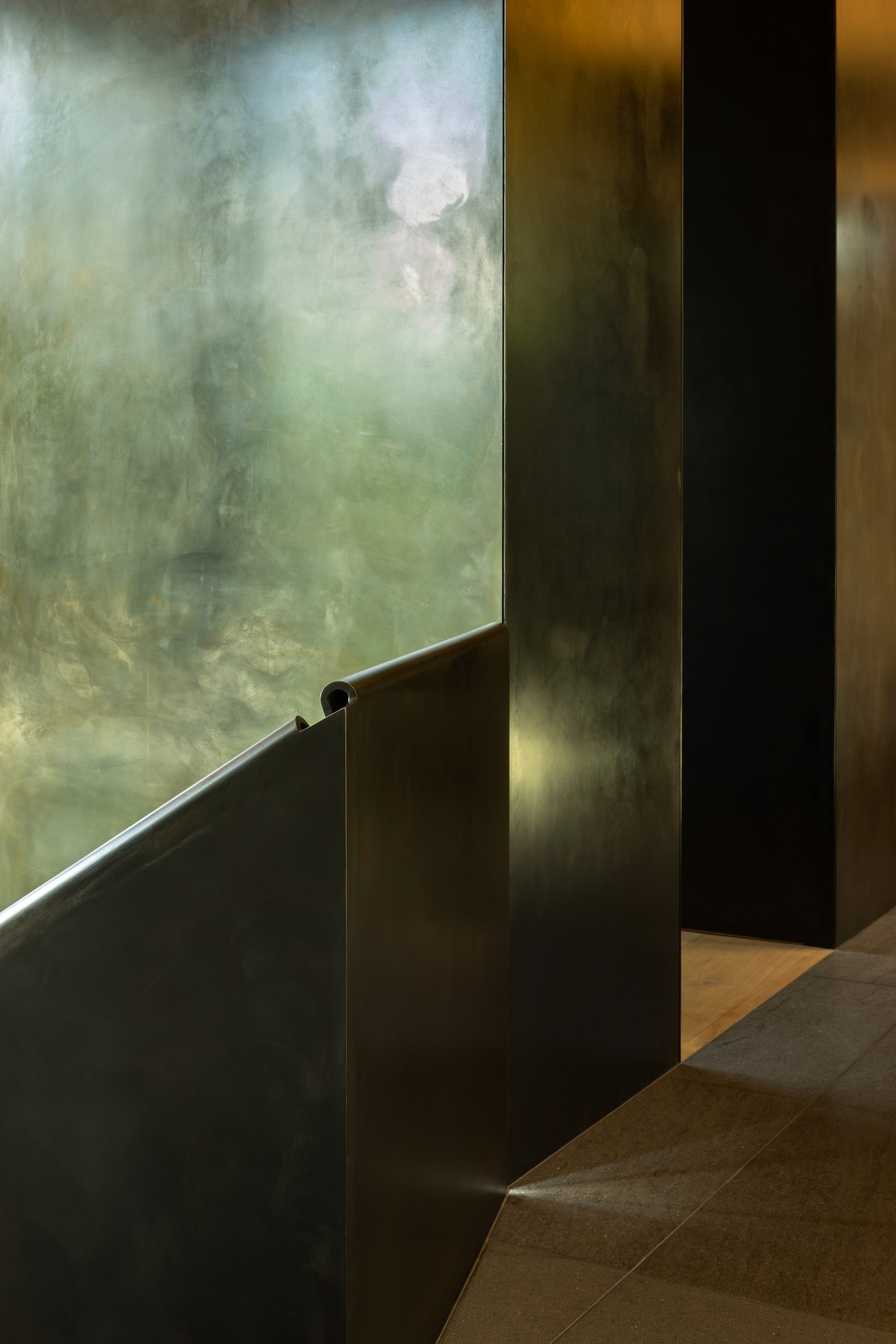 A rendering of a modern cabin home on a sloping hillside in a pine forest