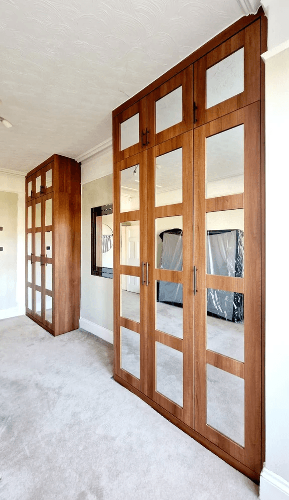 white wardrobe in room with blue pattern wall