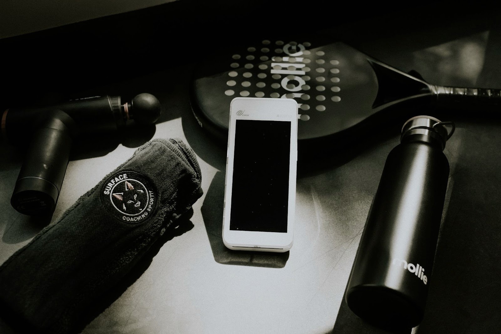 A Mollie Terminal surrounded by sports equipment.