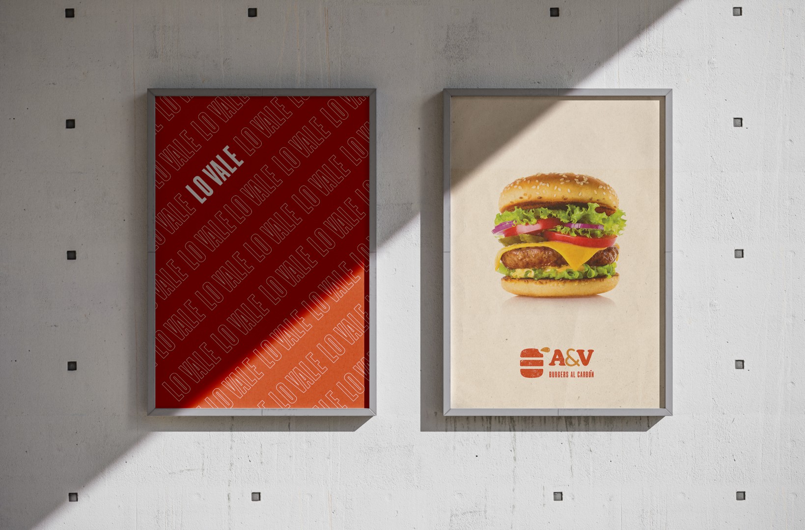 Two posters on a concrete wall dislpalying the A&V's new logo. A burger on the top area of a white poster.