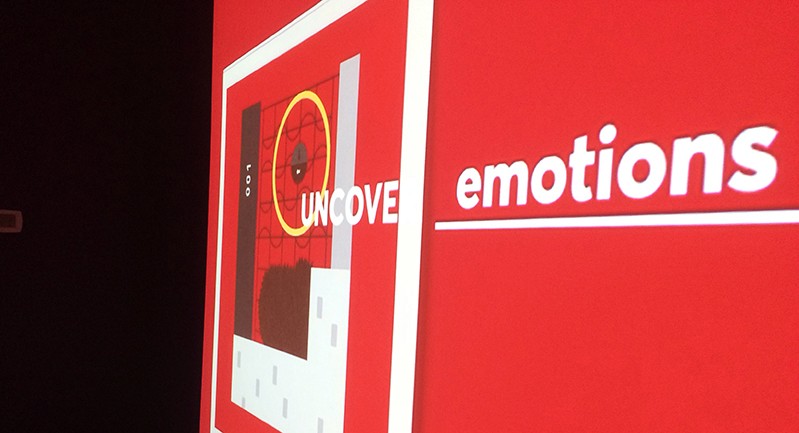 a red image with the white uncover emotions text and some rectangular shapes