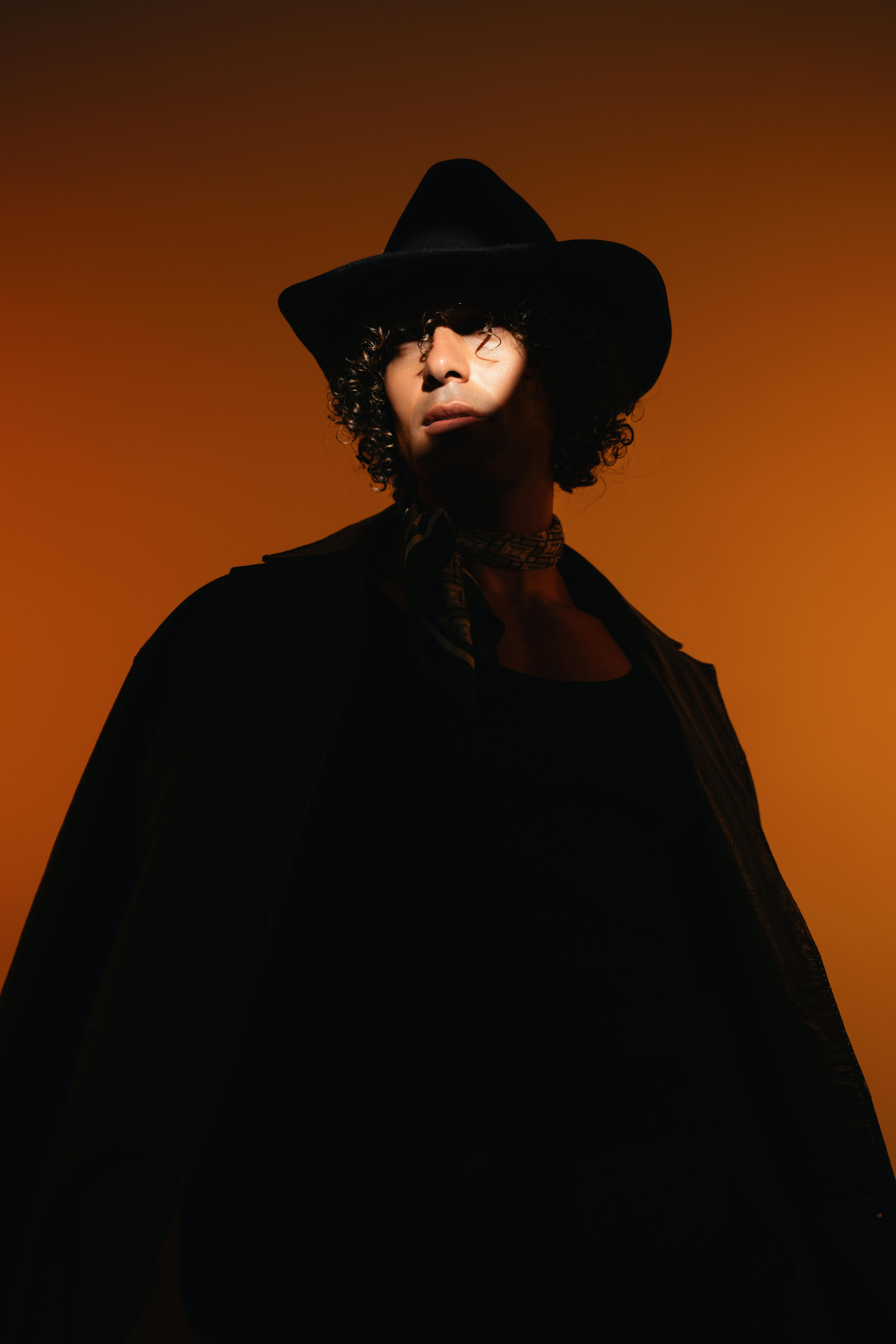 Man in western hat on orange background