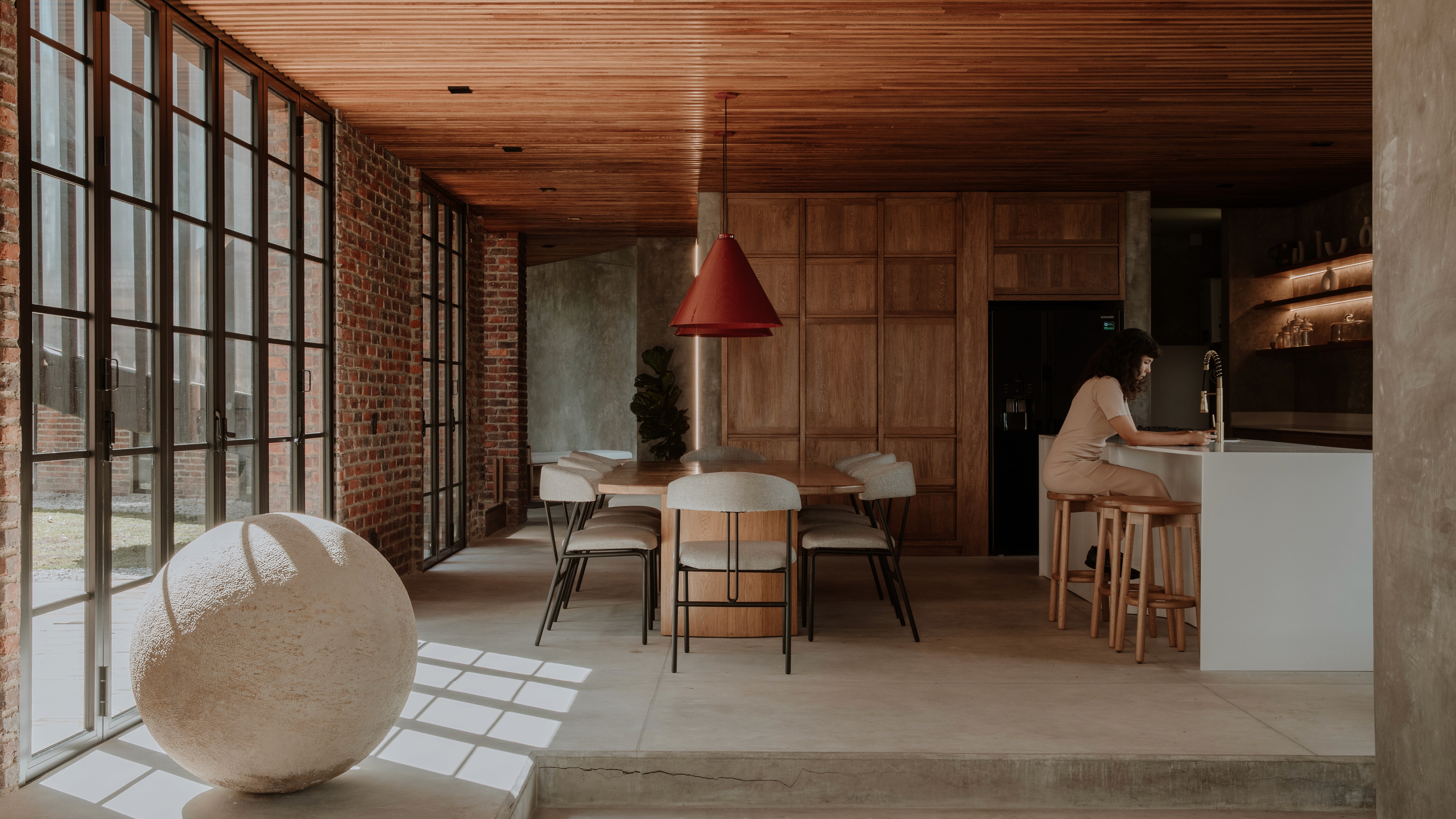 Double-height interior with flowing sculptural forms and warm raking light