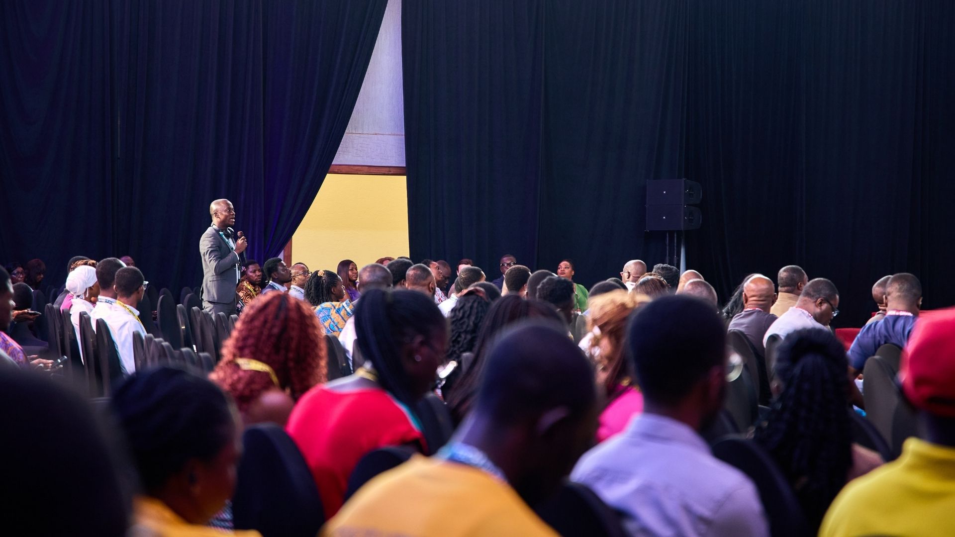 woman sitting while working on laptop and smiling 