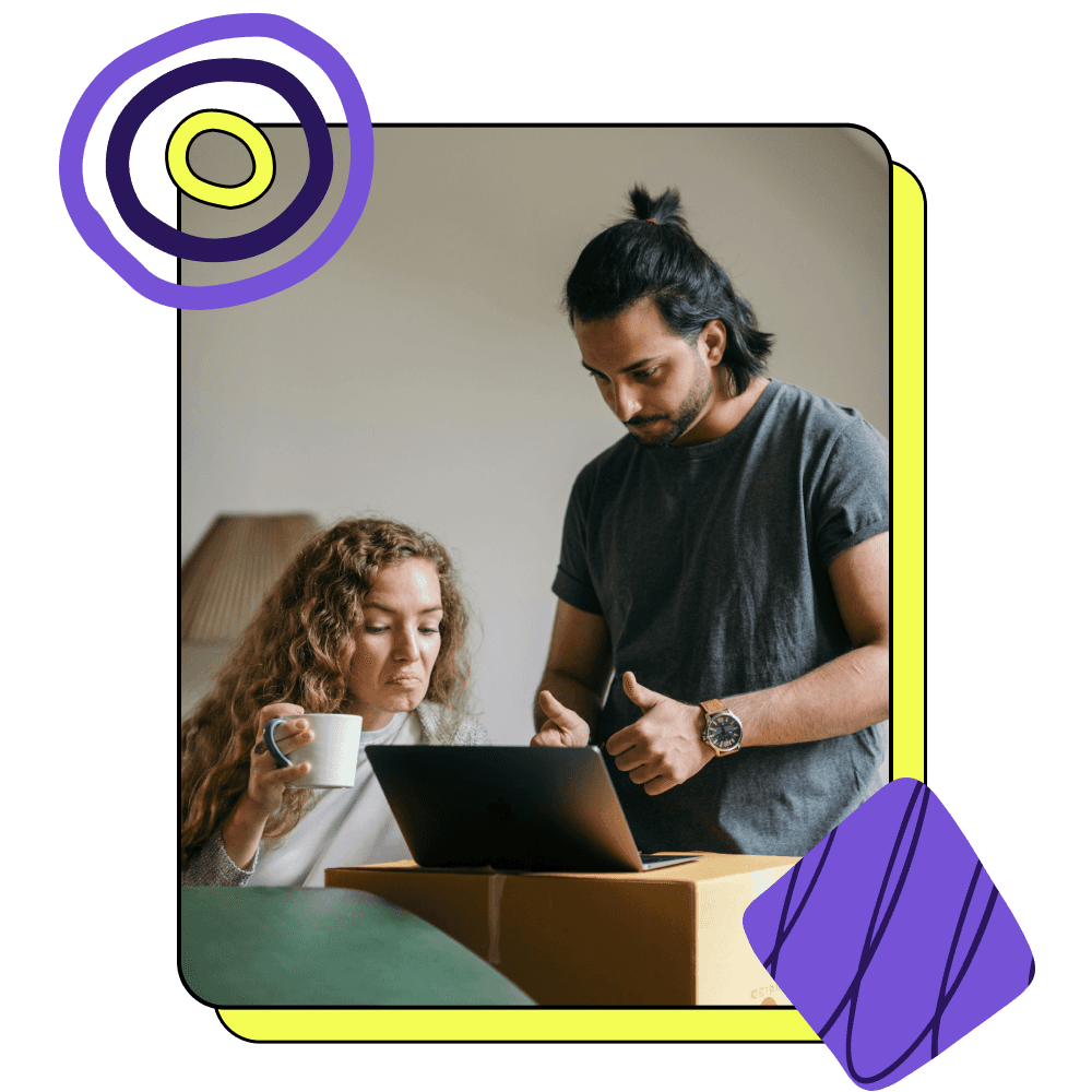 A man and woman looking at a computer.