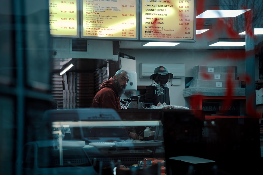 Two people working behind a counter at a diner.