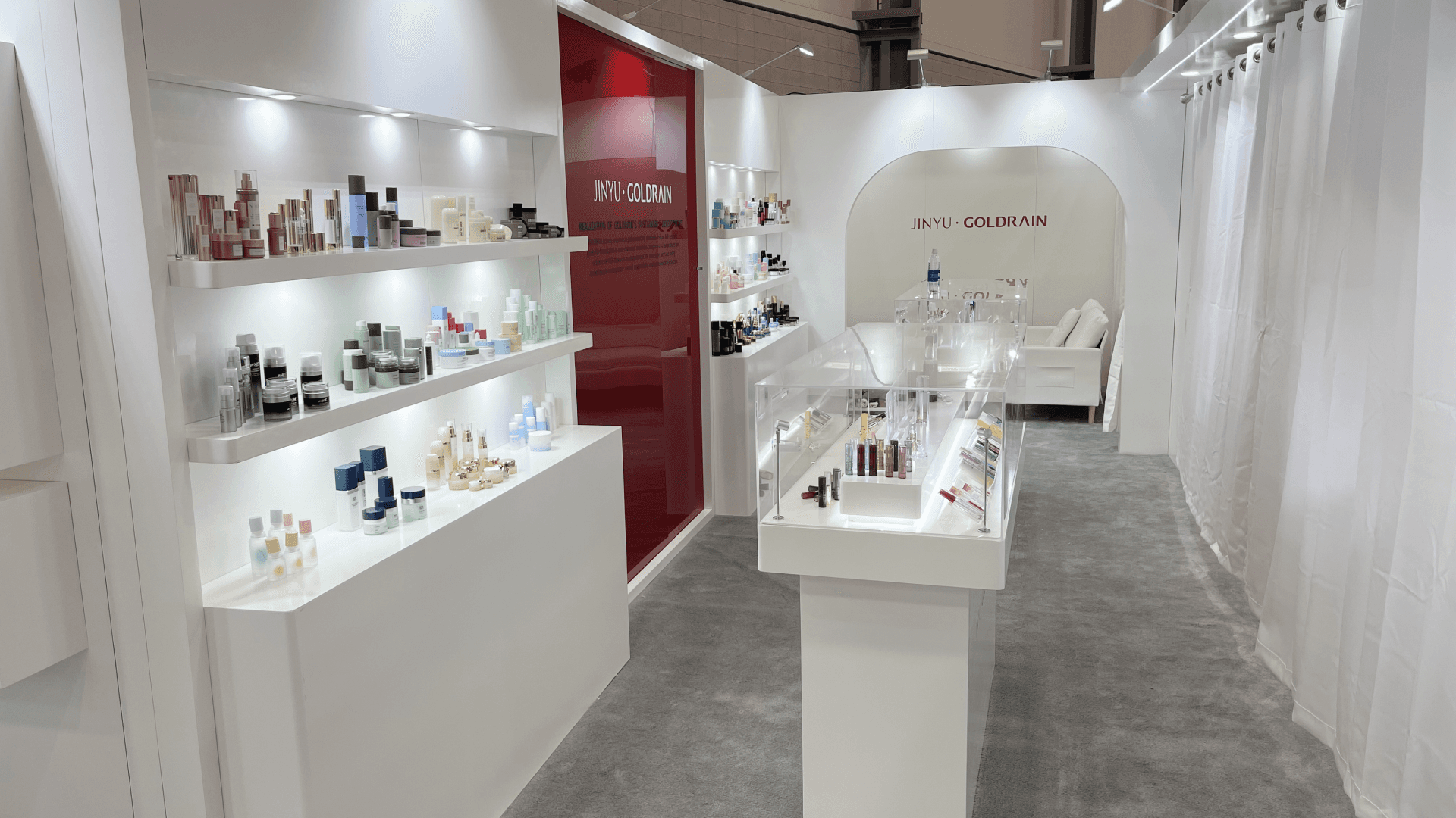 Goldrain 20x30 Cosmoprof 2023 booth overview with illuminated shelving and central product display counter