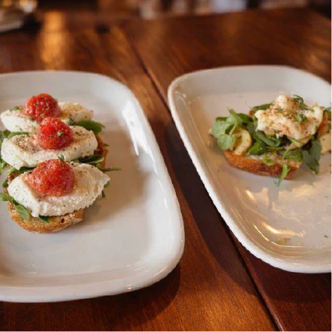 a table topped with boxes of sandwiches and pastries