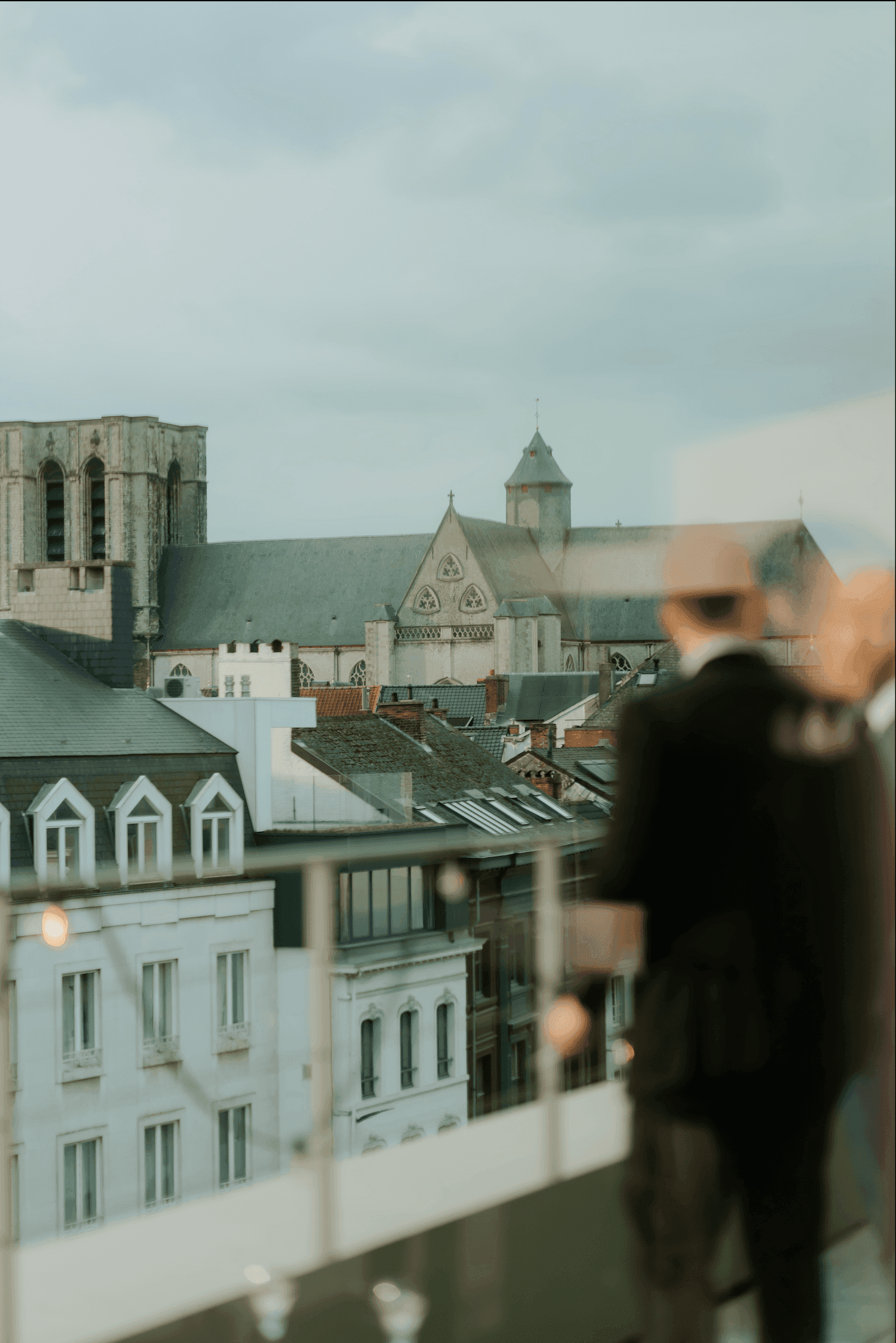 A large group photo of diverse team members gathered in an industrial-style space with arched ceiling.
