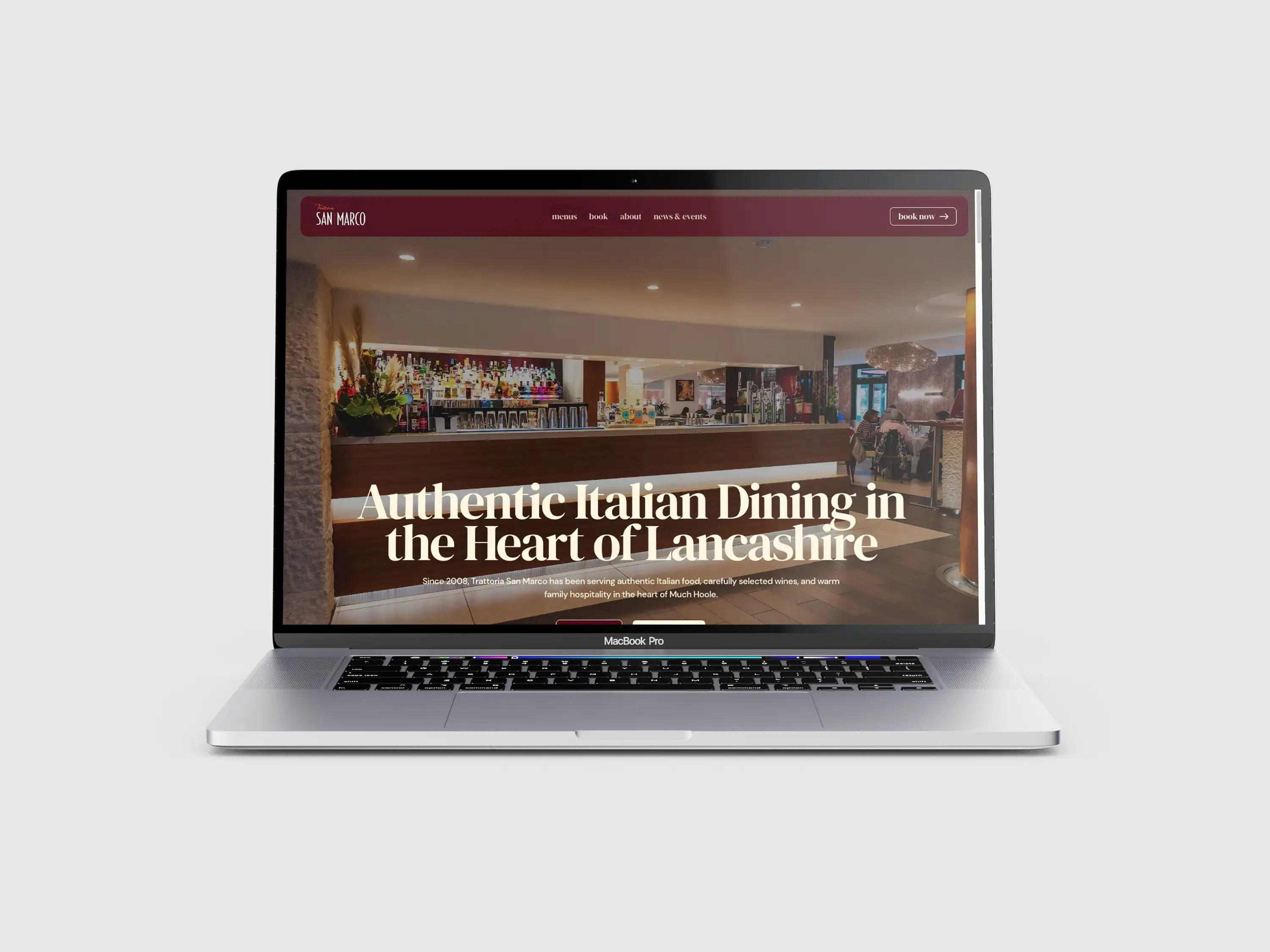 San Marco Group restaurant website displayed on a laptop, with burgundy navigation and an interior photograph.