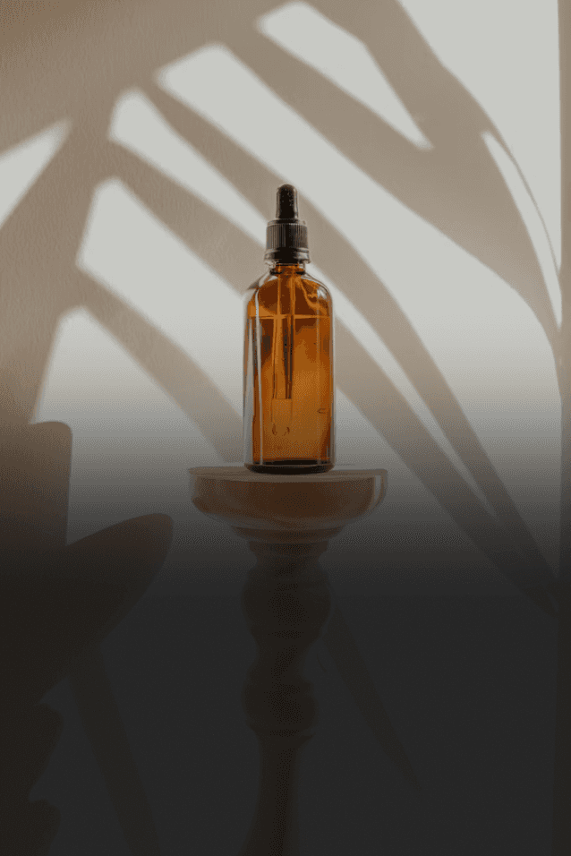 gold and black bottle on white wooden table