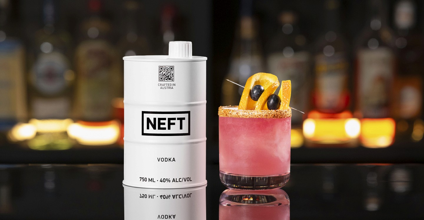 A NEFT Barrel and a glass of Blueberry NEFT-A-Rita on a bar counter.