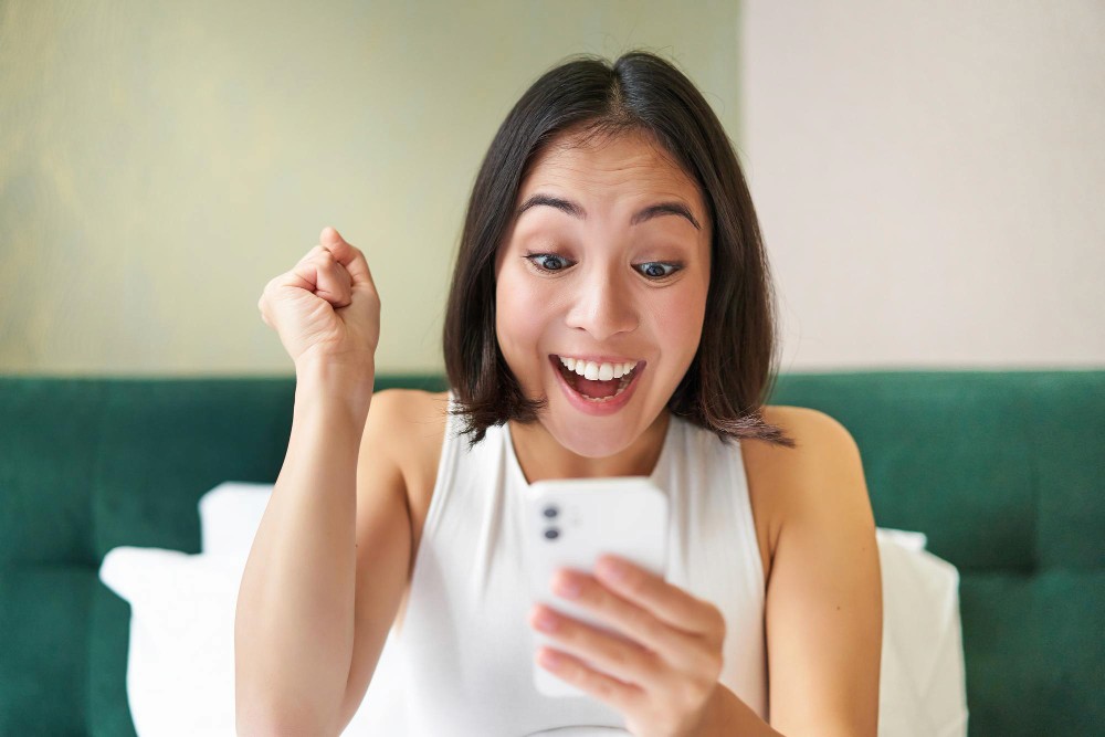 Woman celebrating win on rewards from loyalty program