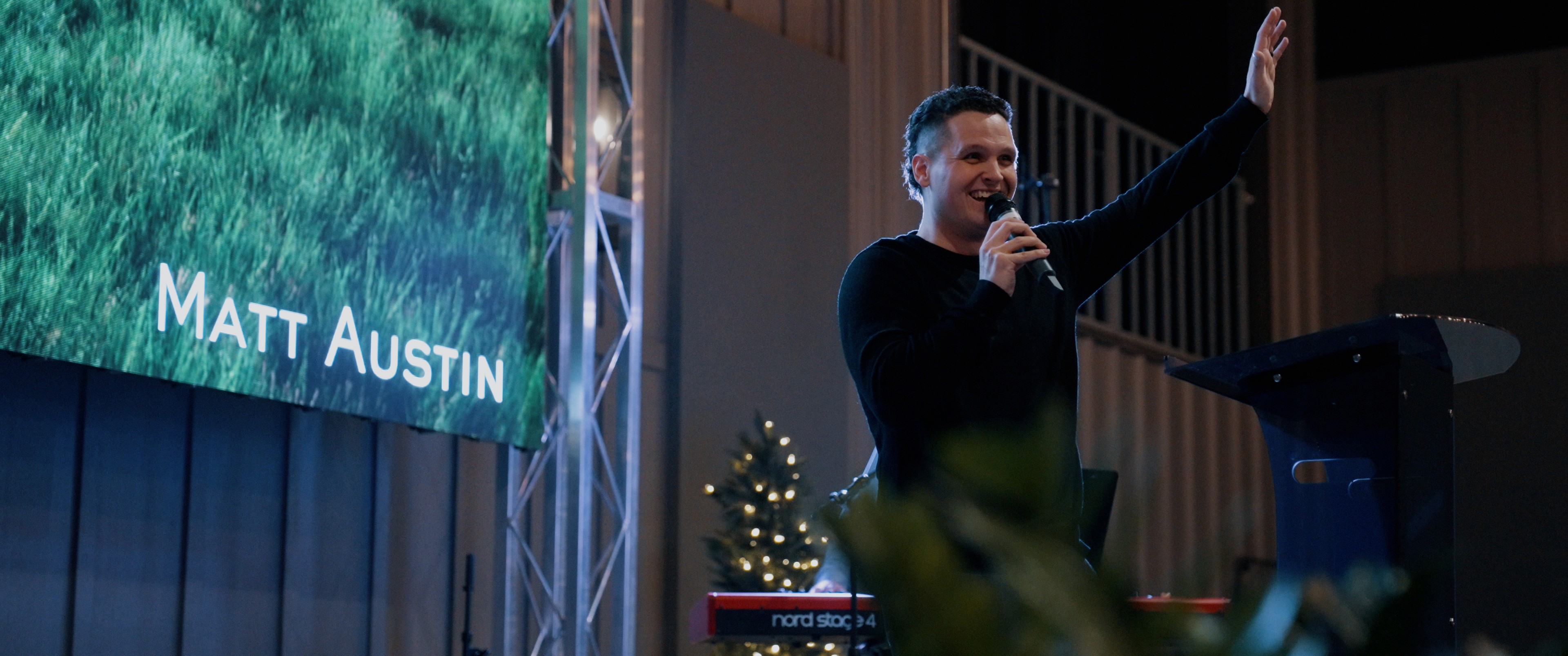 a woman standing in front of a projection screen