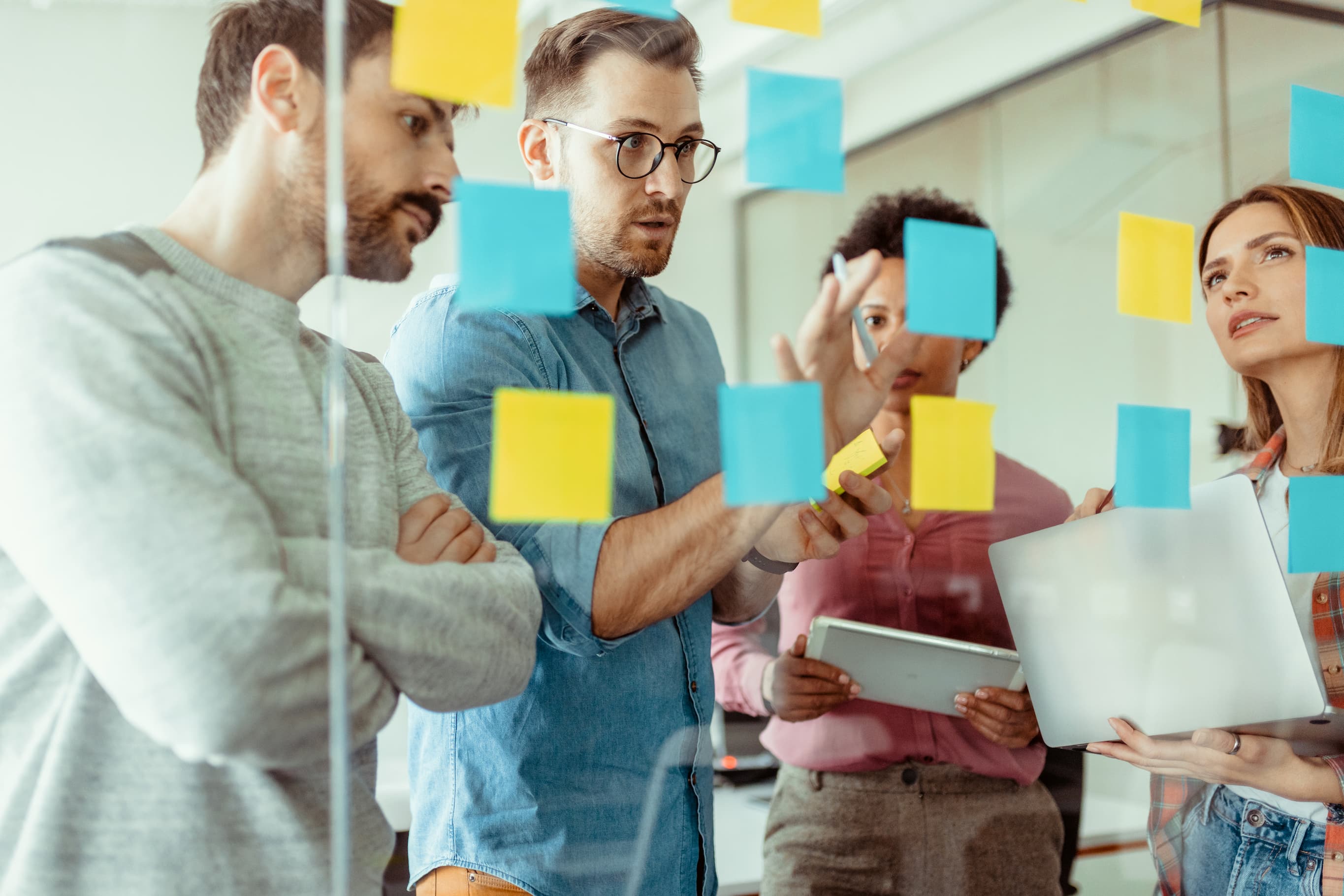Four people working on a strategy board.