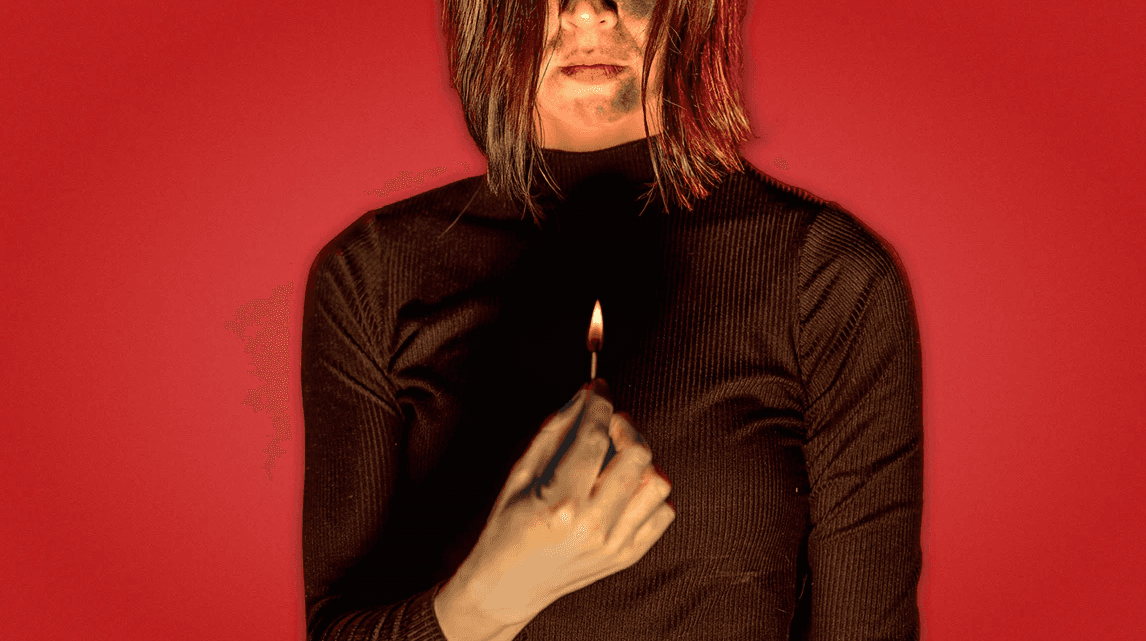 a person from nose down, wearing a brown long sleeve sweater, holding a lit match