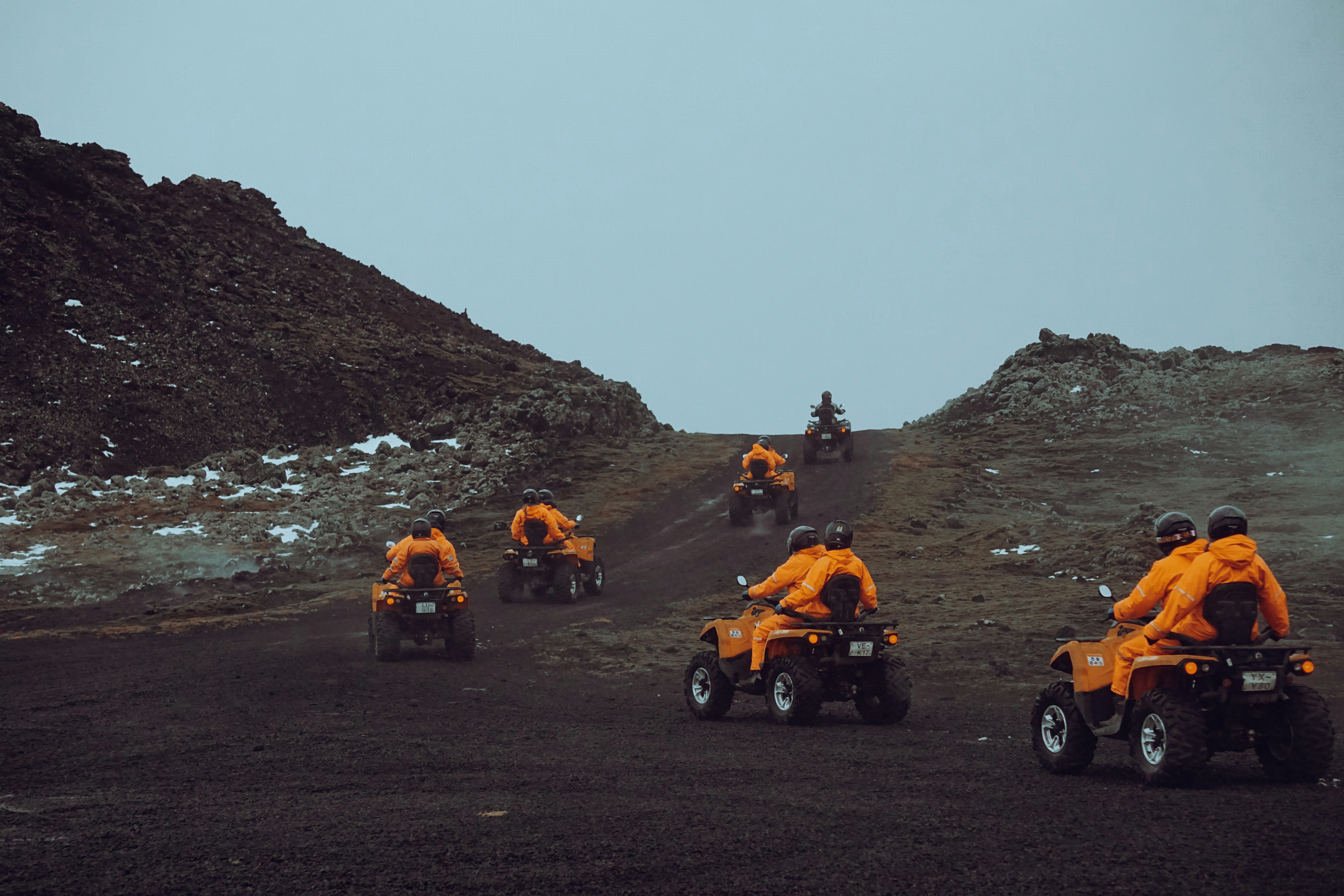Travelers riding ATVs across volcanic landscapes in Ölfus.