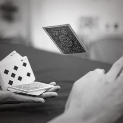 Photo of card trick being performed at the richmond tattoo and arts convention