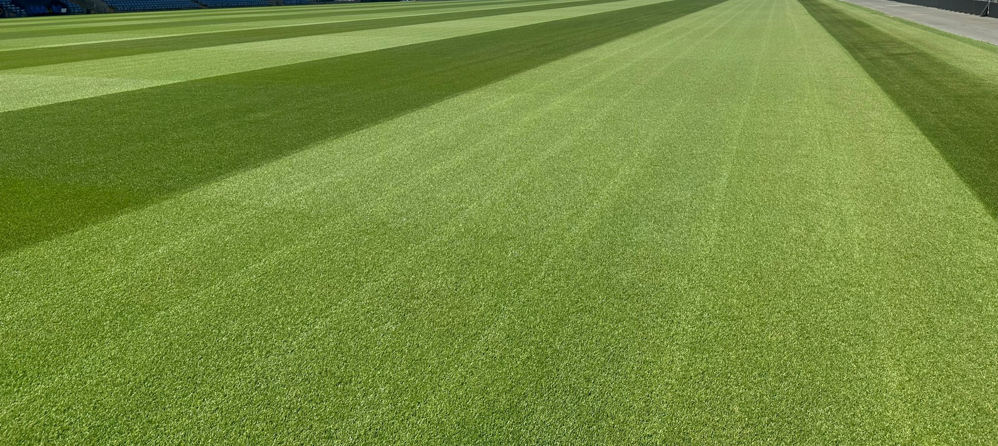a large building with a clock tower in the middle of a field