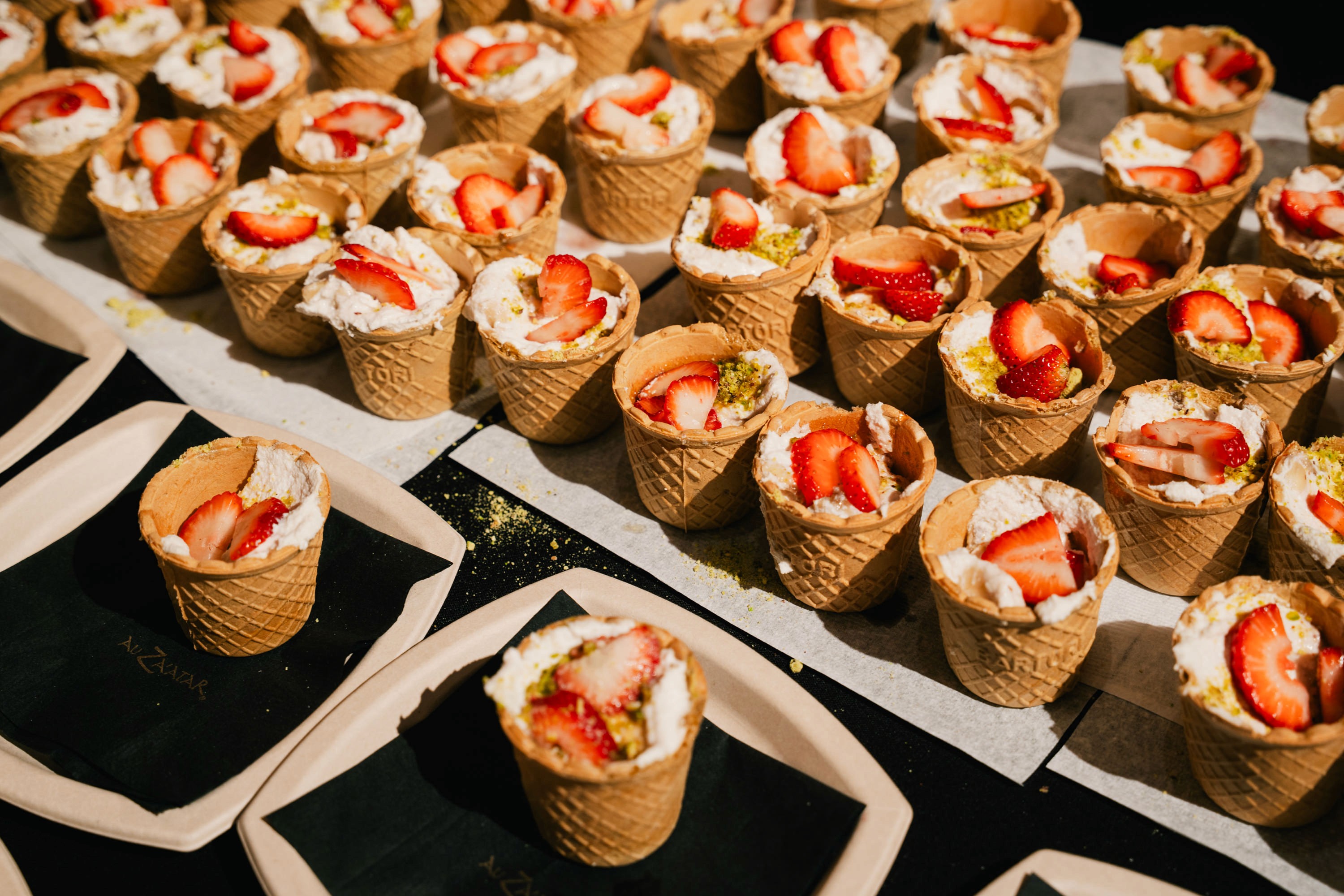 A decorative dish with red fruit, white garnish, and mint leaves.