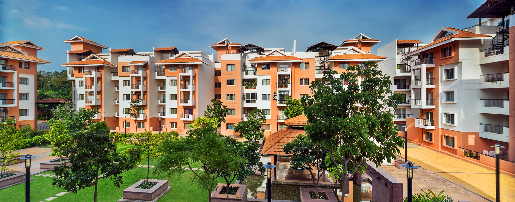 Aerial view of a winding road cutting through rocky terrain with patches of grass.