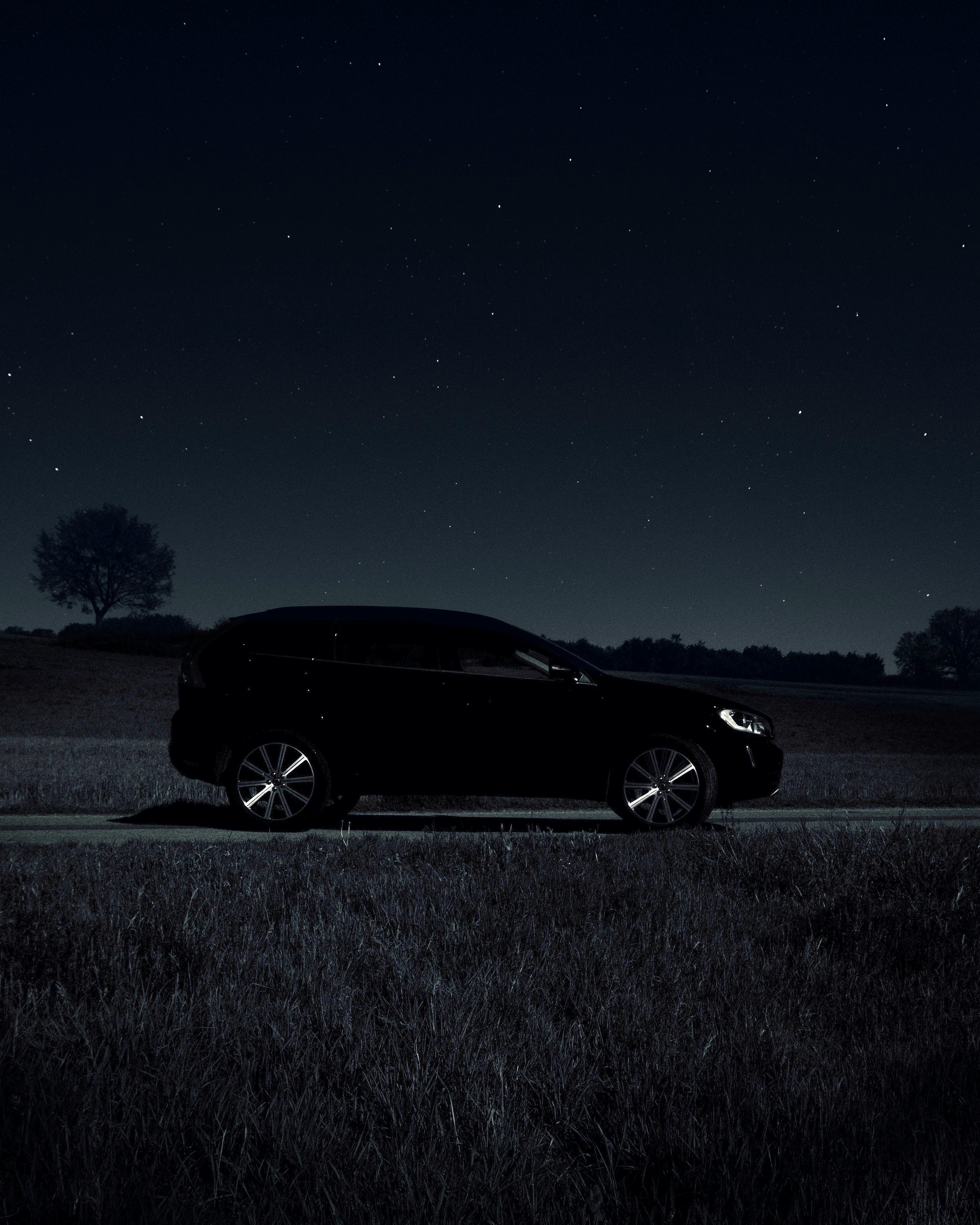black car on gray asphalt road during night time