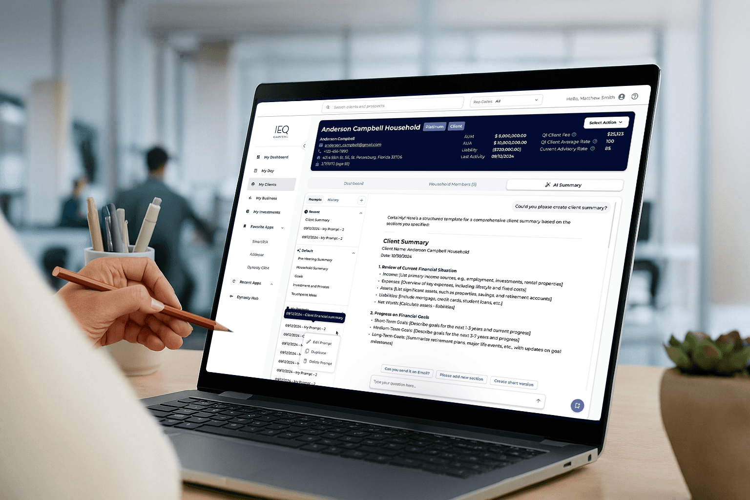 Wealth management software dashboard shown on a laptop, featuring client household overview, financial metrics, and AI‑powered client summary tools.