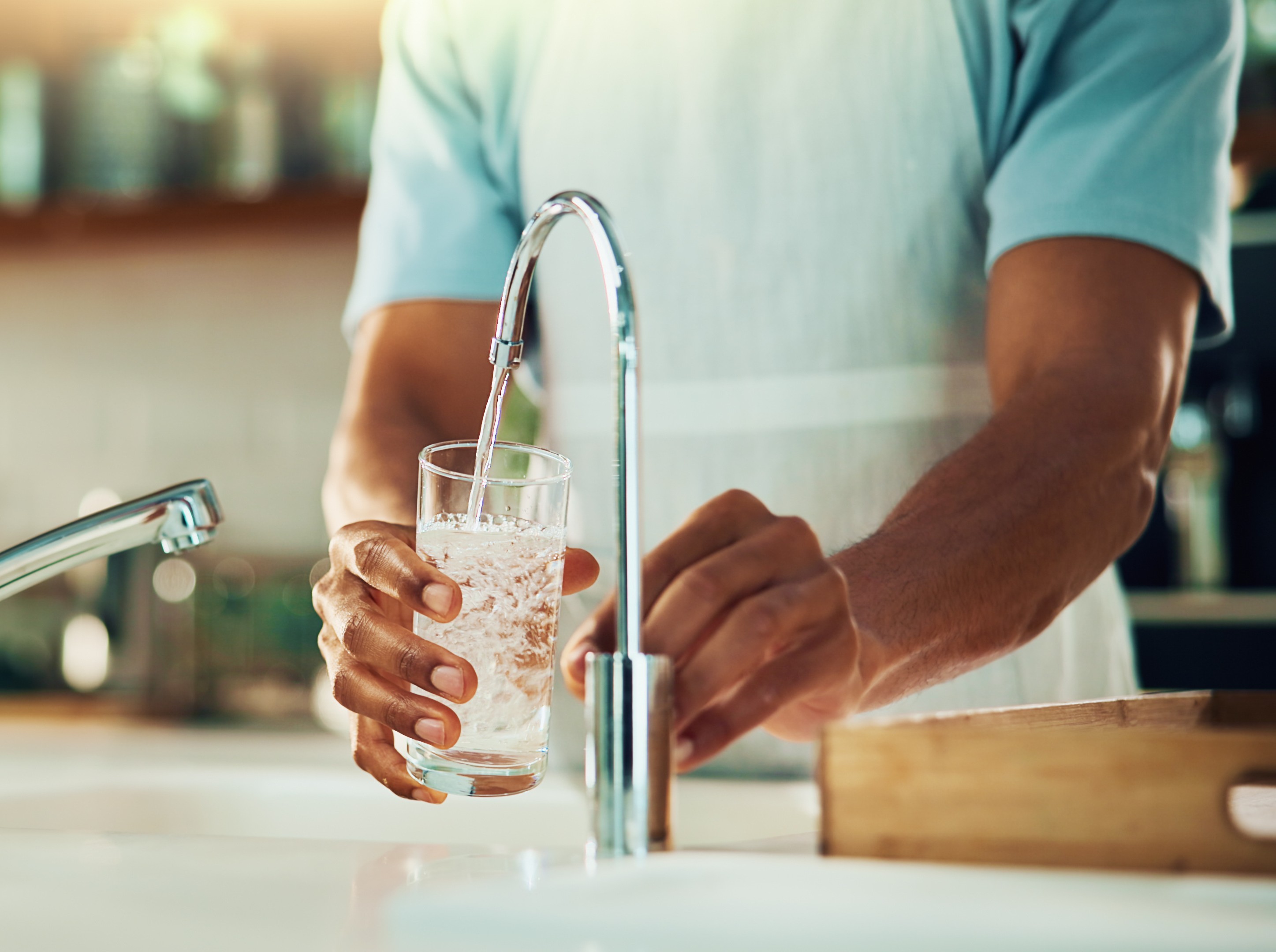 person making the healthy choice to drink water after doing an indoor walking workout for weight loss