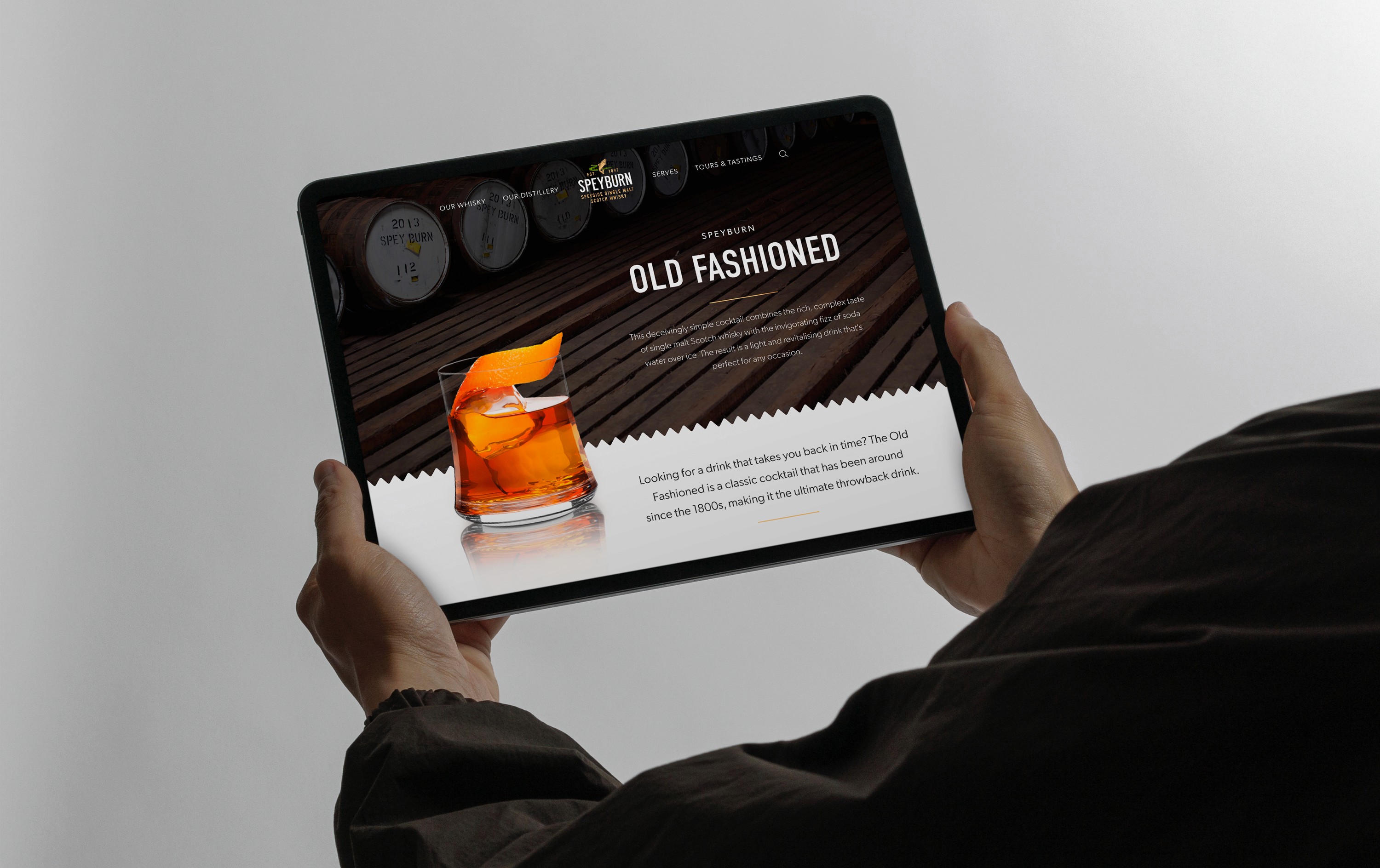 Person holding iPad looking at Speyburn Whisky's Old Fashioned Cocktail page