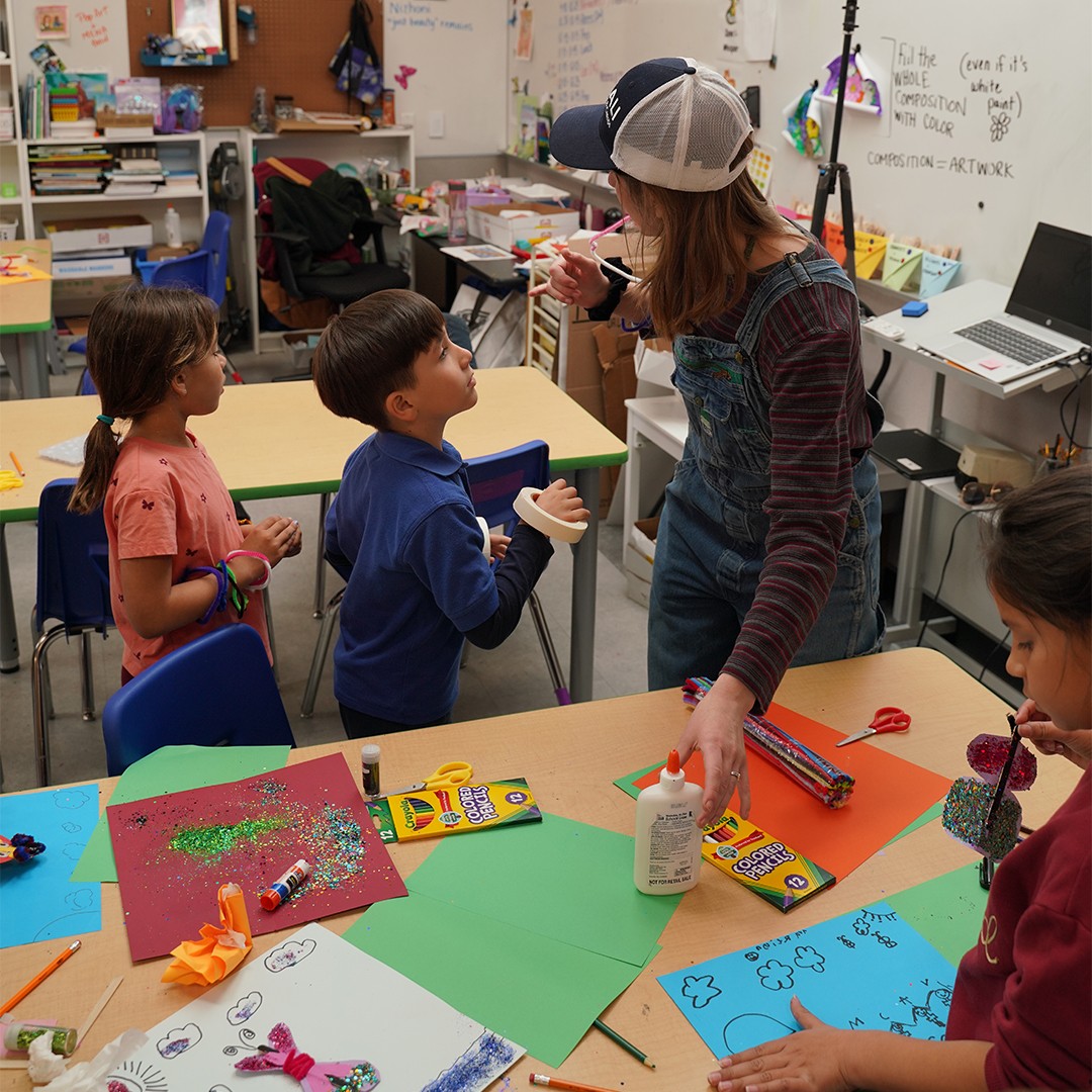 students creating crafts with an educator during a back-to-school enrichment activity in the classroom