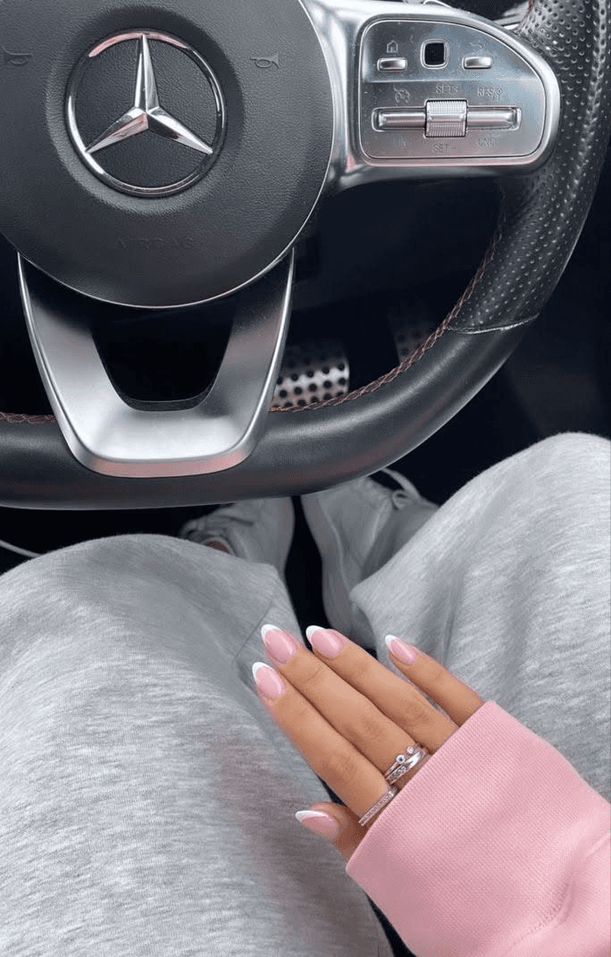smiling woman wearing white and black pinstriped collared top