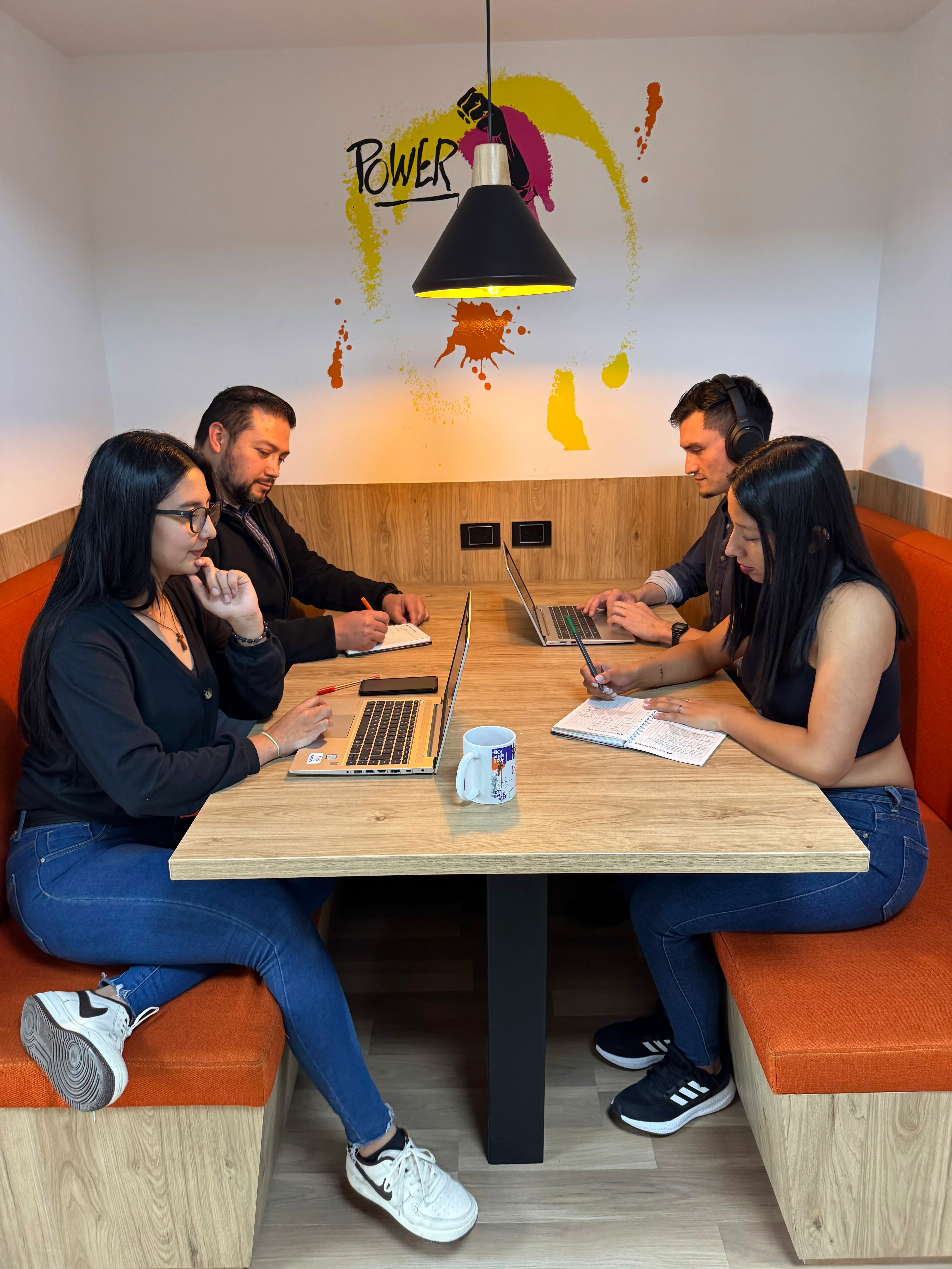 Personas sentadas en una mesa trabajando juntas