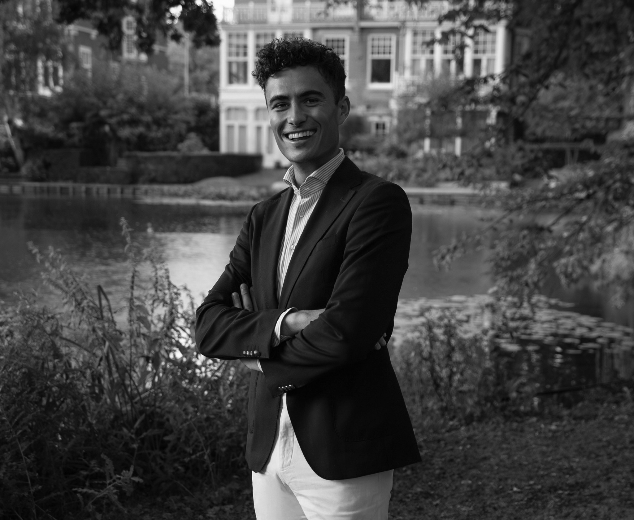 Portrait of a person in a pink sweater against a light background