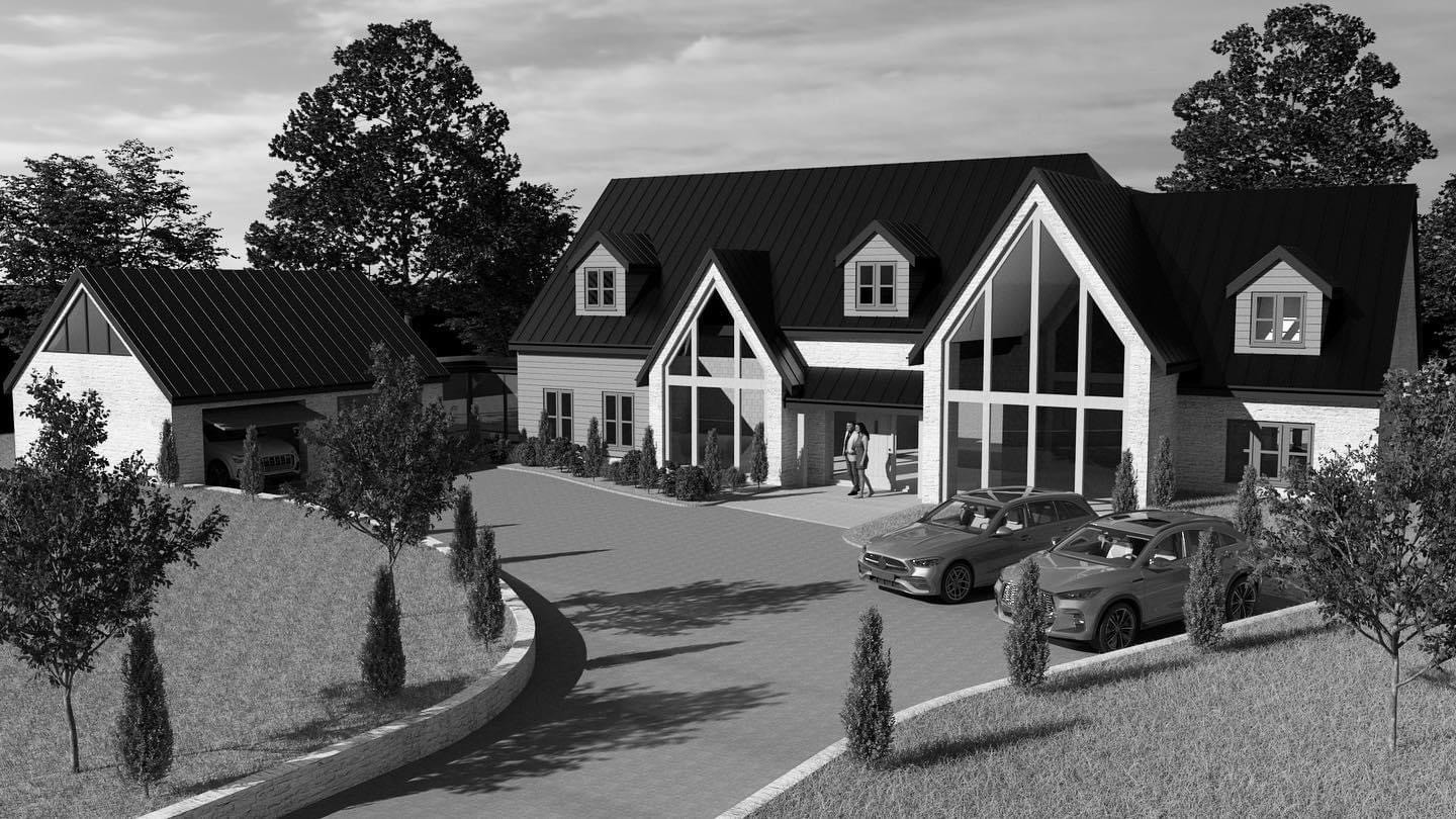 Modern large house in rural setting with gabled roof and glass