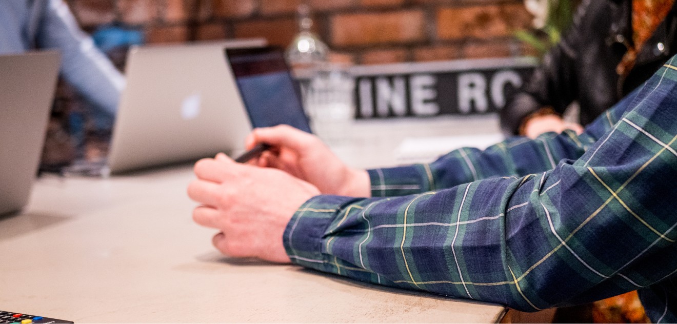 A person using a laptop on the table.