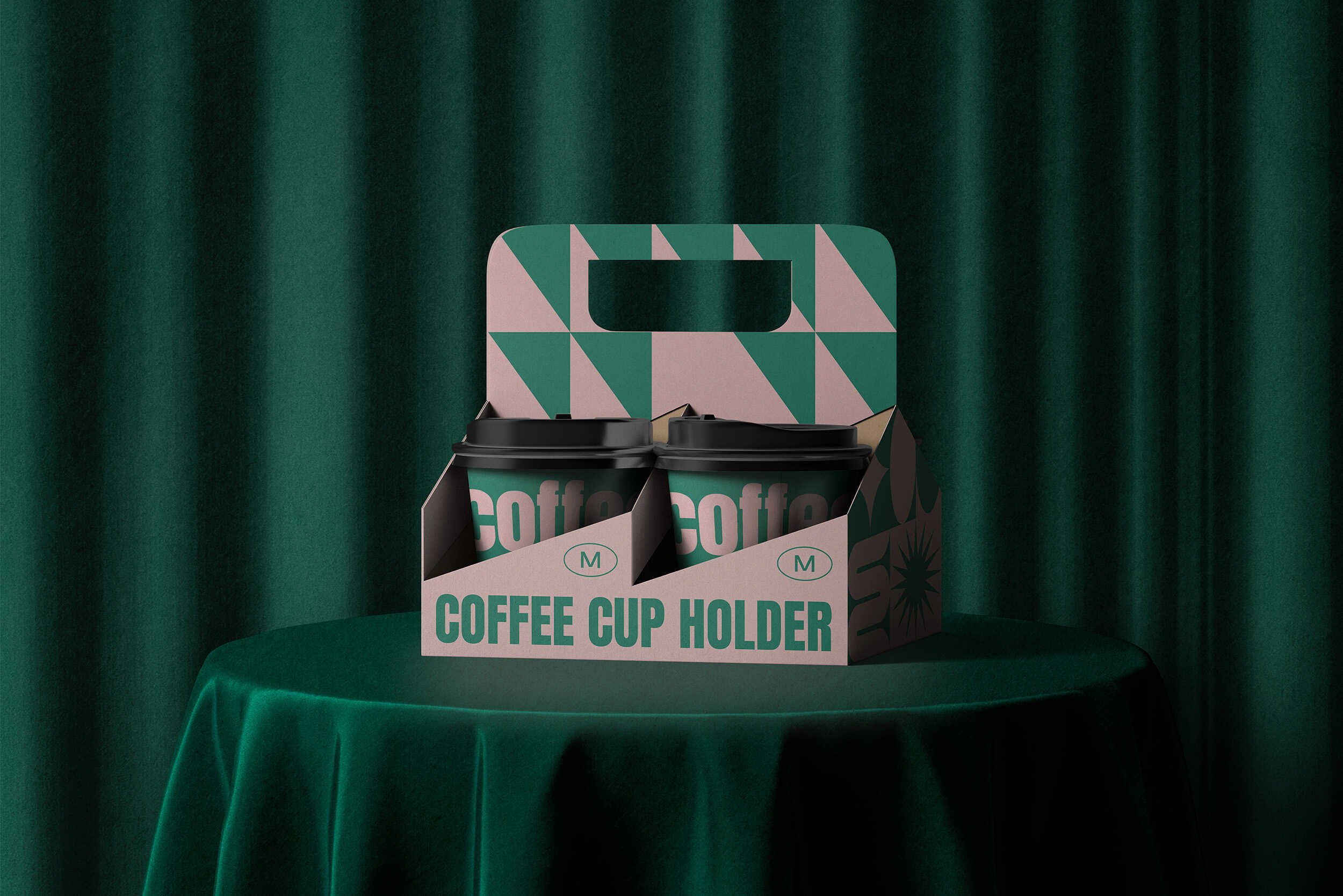 Branded coffee cup carrier holding two cups on velvet green draped table