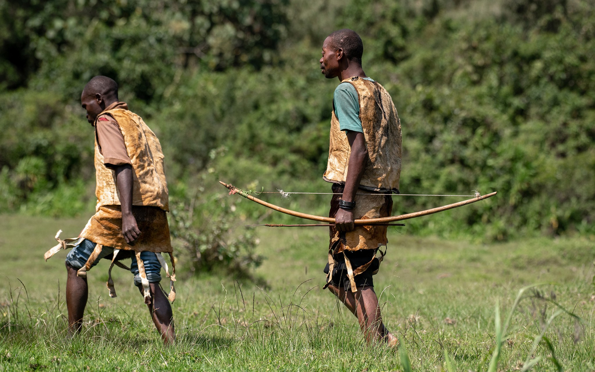 Dressed in traditional attire and carrying bow and arrow, Batwa men reenact their ancestral hunting way of life for tourists - turning cultural heritage into a livelihood, and offering a better alternative to poaching or encroaching on protected park land.