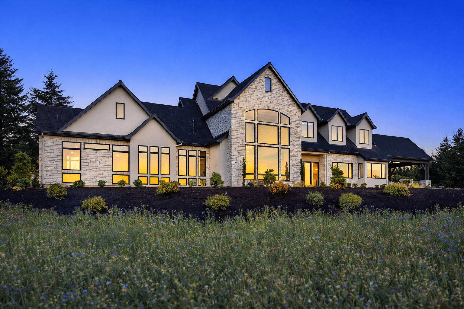 Modern indoor space with large glass doors, lush greenery, and a cozy seating area visible beyond.