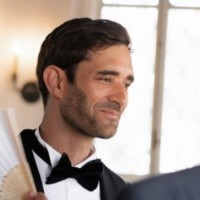 a man with a goatee smiles at the camera