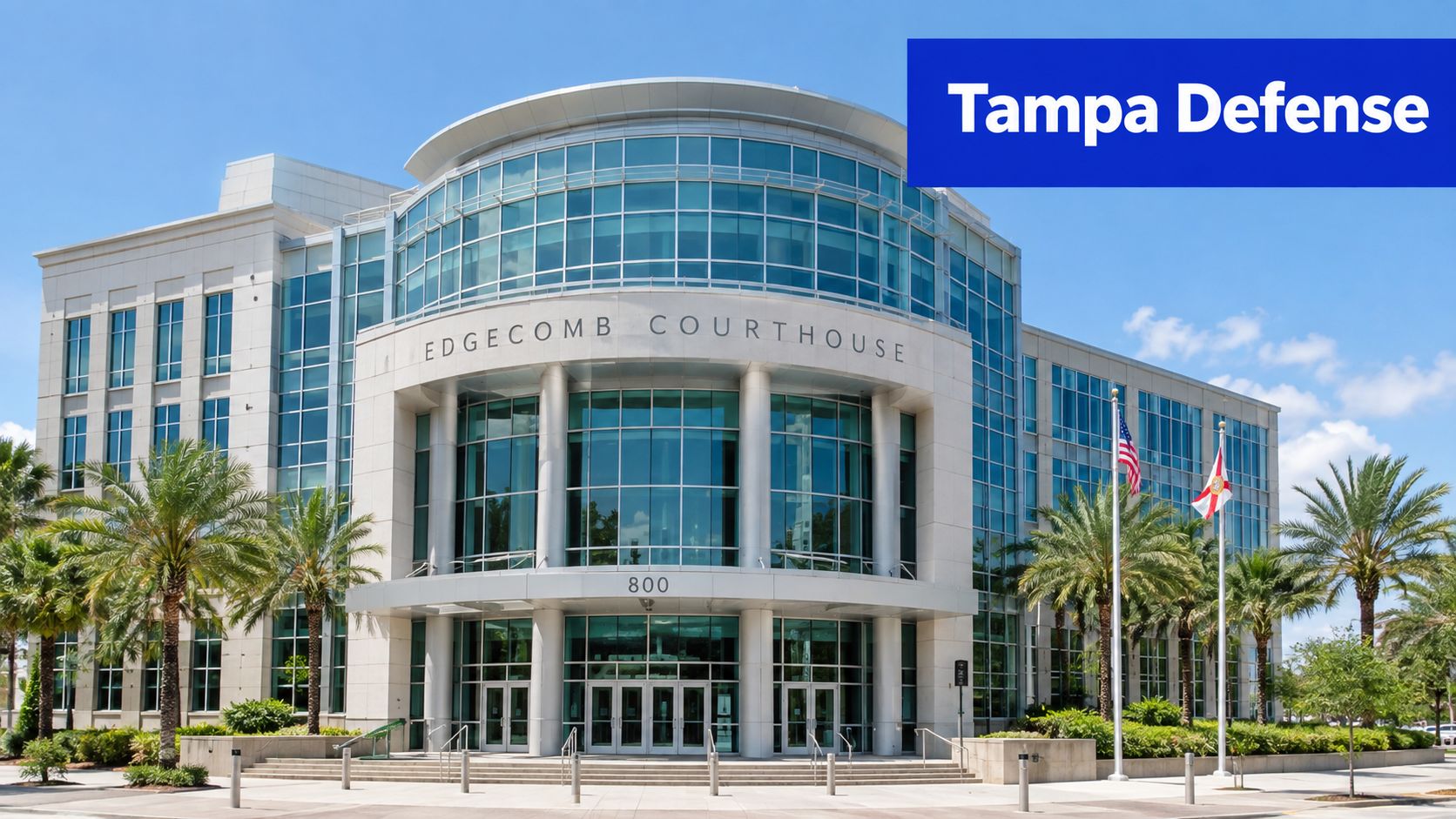 The modern glass facade of the George E. Edgecomb Courthouse in Tampa under a clear blue sky.
