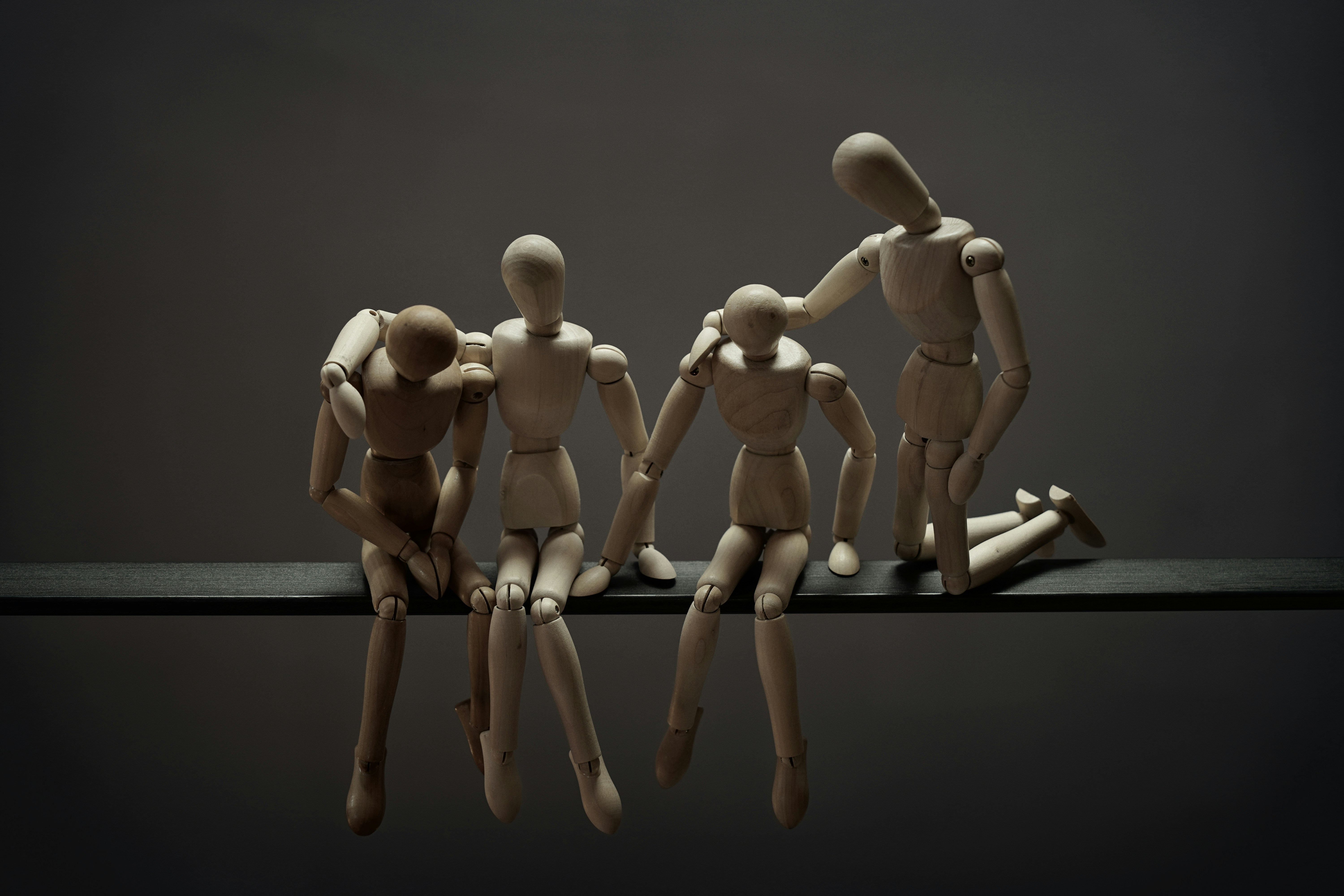 a group of wooden mannequins sitting on top of a table