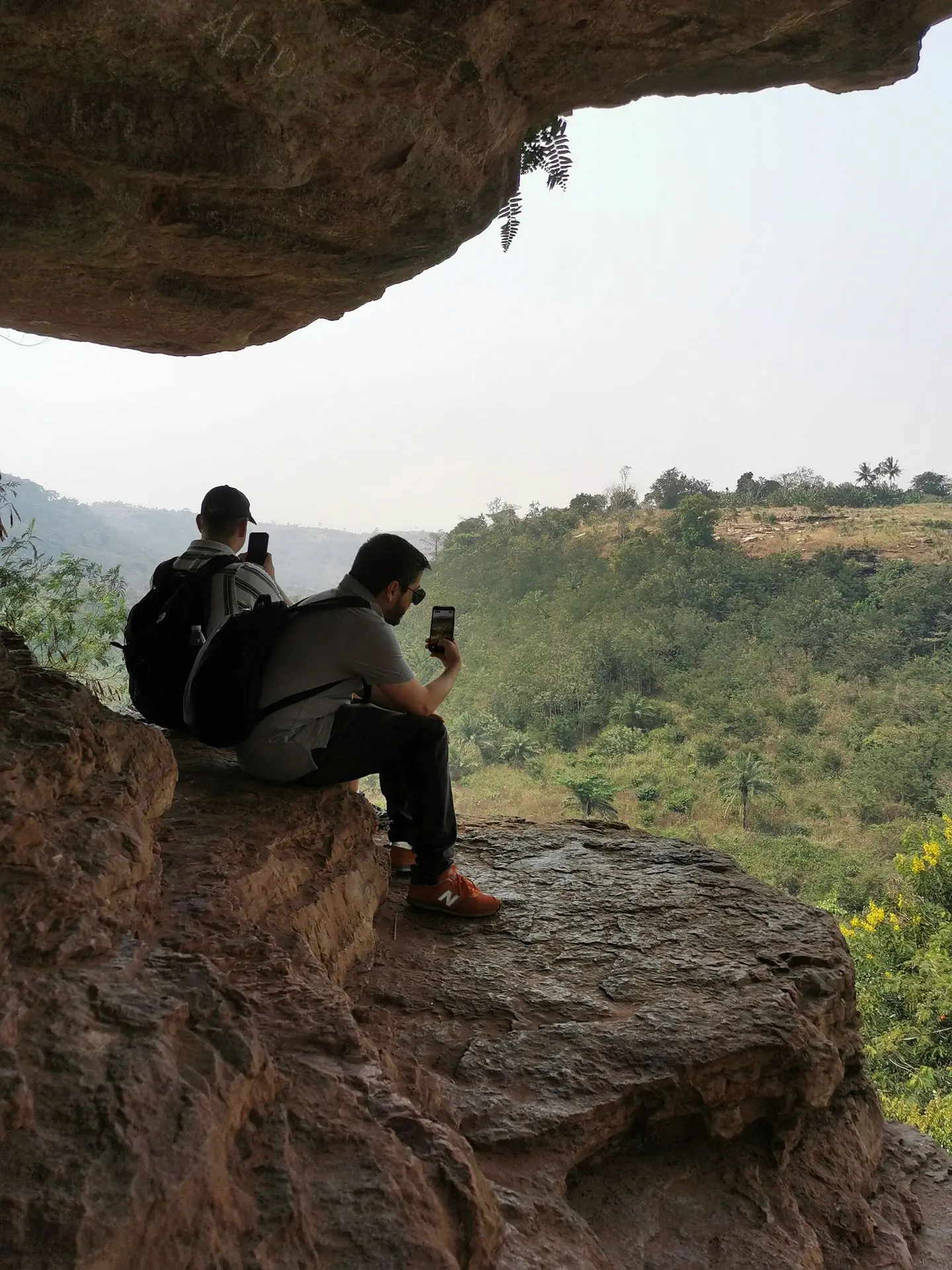 Travelers photographing the scenic landscape of Ghana’s Eastern Region near Boti Falls. 