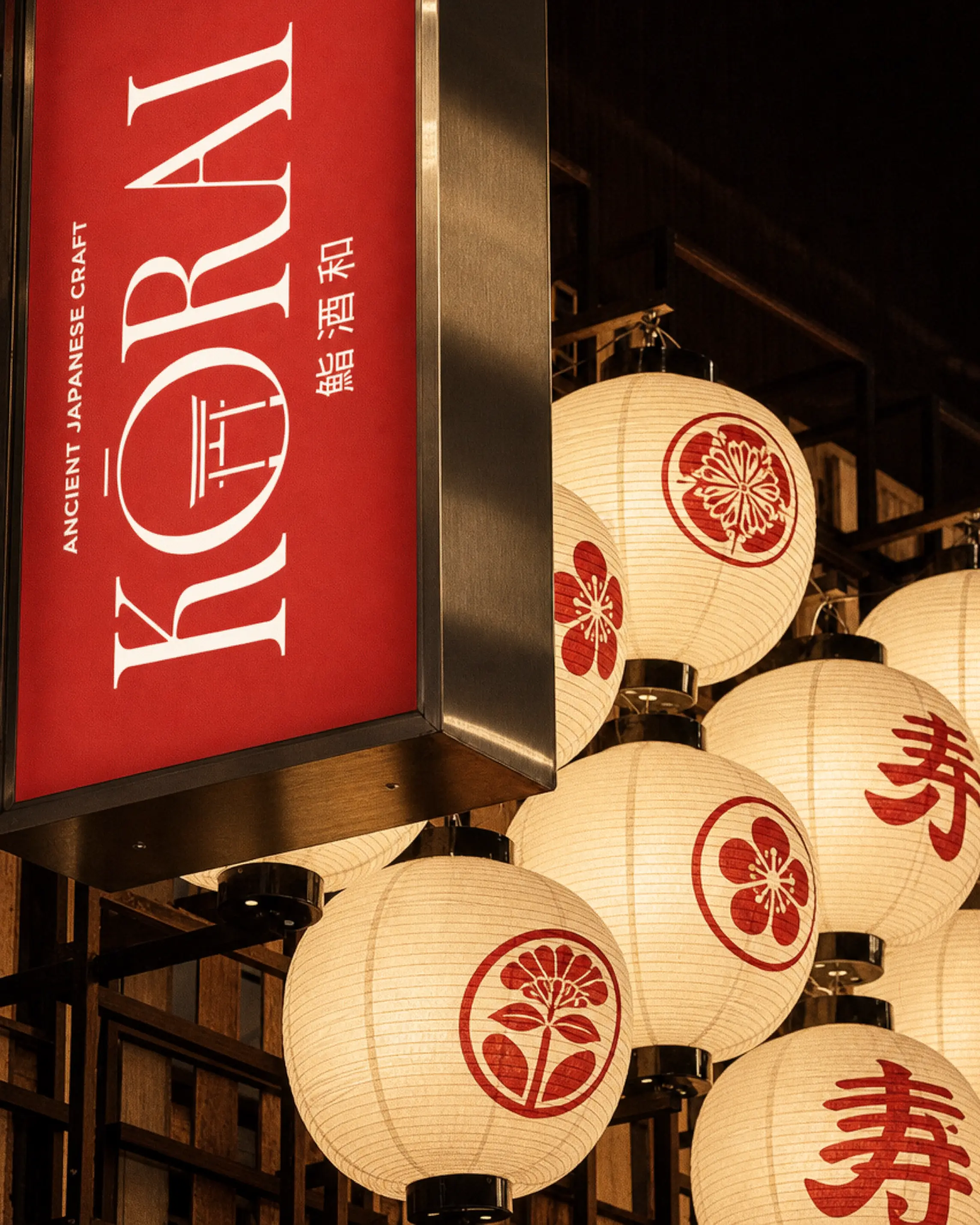 Exterior signage for Kōrai Japanese sushi restaurant featuring a red and white storefront design, premium branding elements and traditional Japanese-inspired visual details.