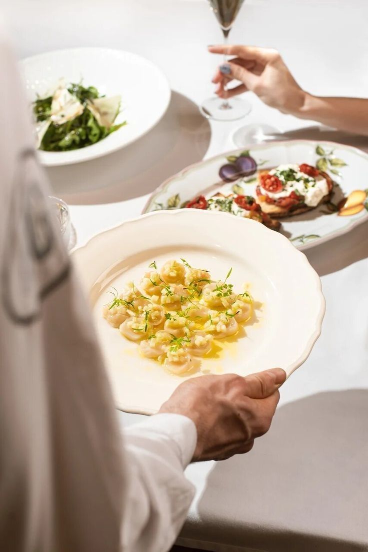 Chef presenting a handcrafted pasta dish at Dhoom Toronto during New Year’s Eve dinner service, showcasing fine dining plating and elegant modern Indian hospitality.