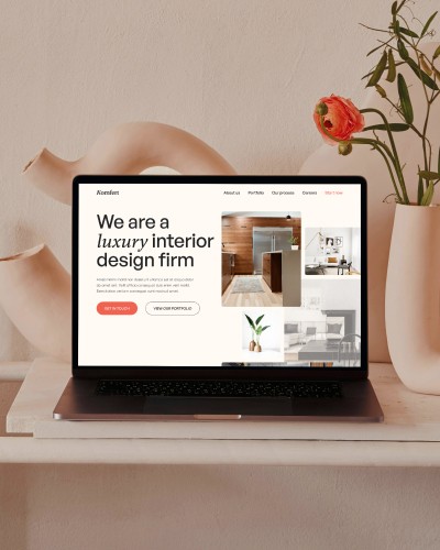 Website design of a creative agency displayed on a laptop, showcasing their work.