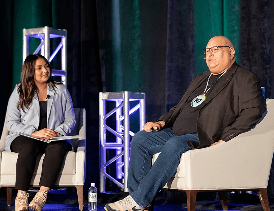 group of women in red and white dress standing on brown wooden bar during daytime