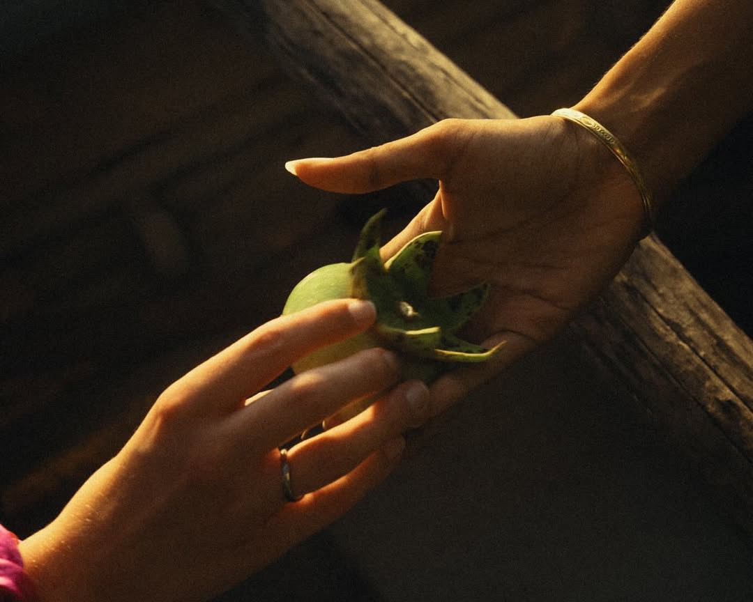a group of women standing on top of a sandy beach