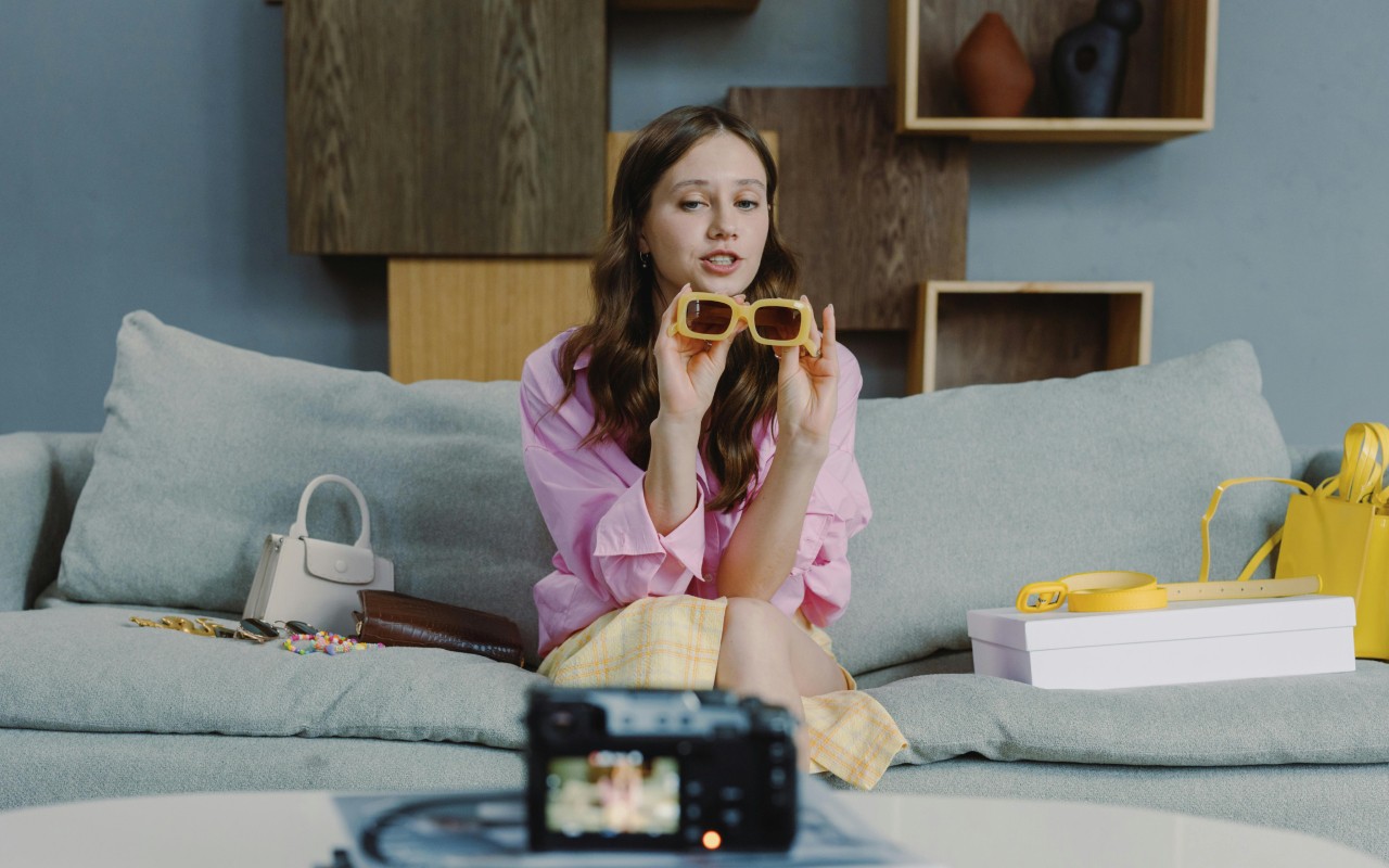 A girl recording a product video with a camera.