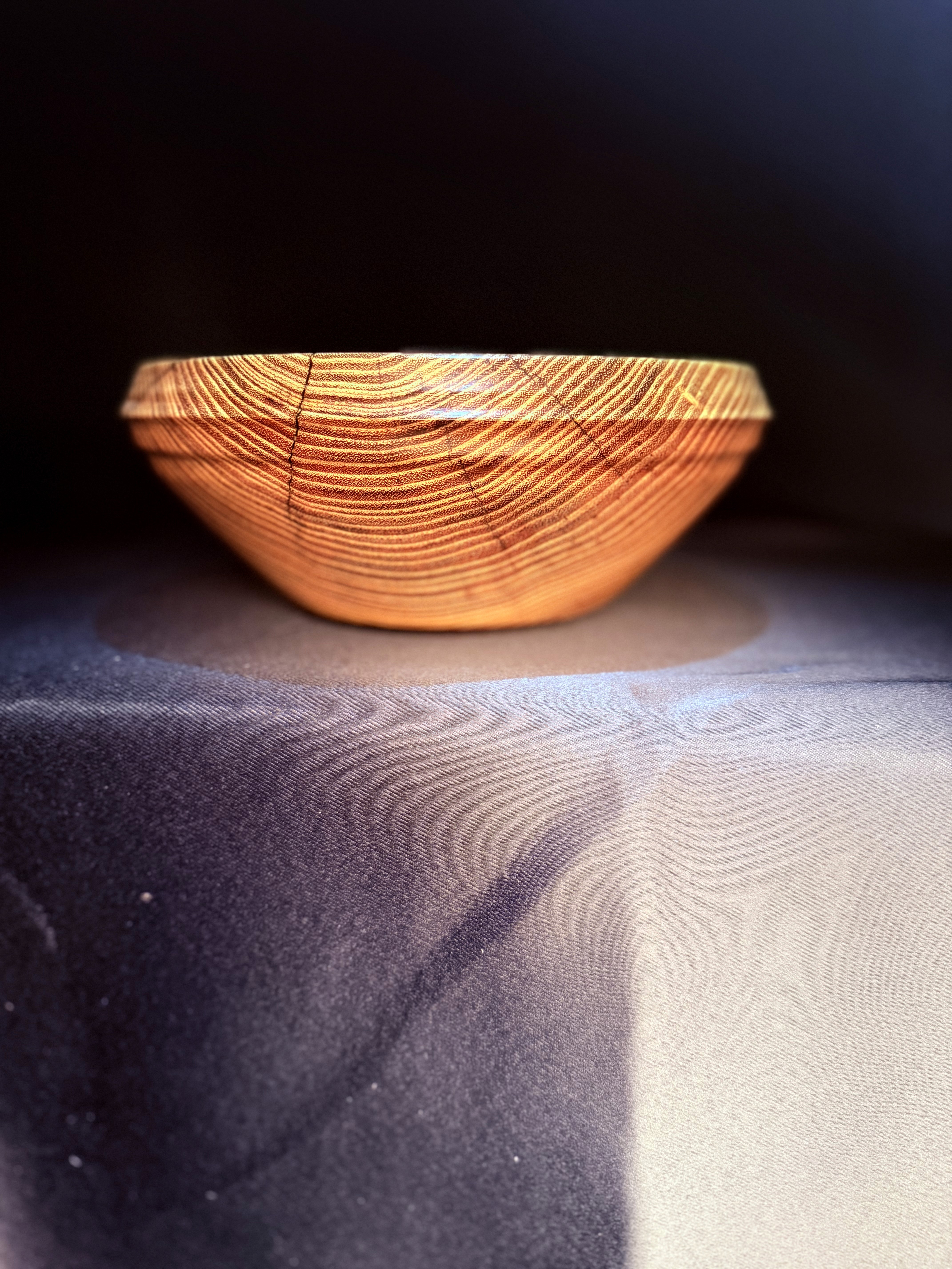 Supporting view of the hand-turned Glowing Locust Bowl in natural light.